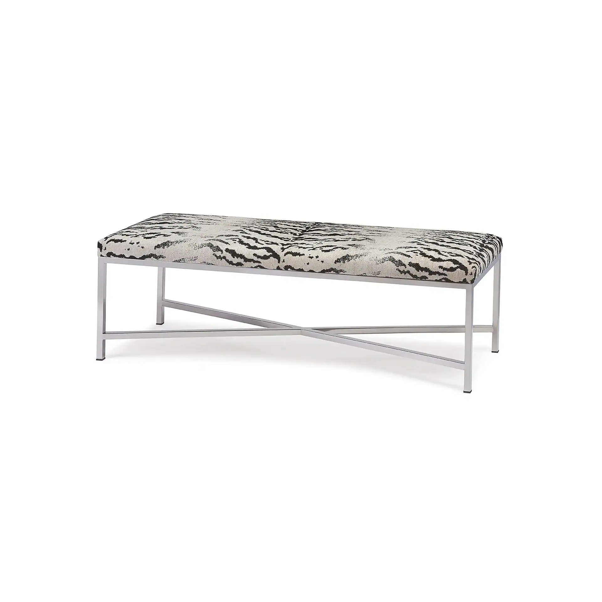 A rectangular bench with a black and white tiger print top and a polished silver metal frame with an X-shaped base.