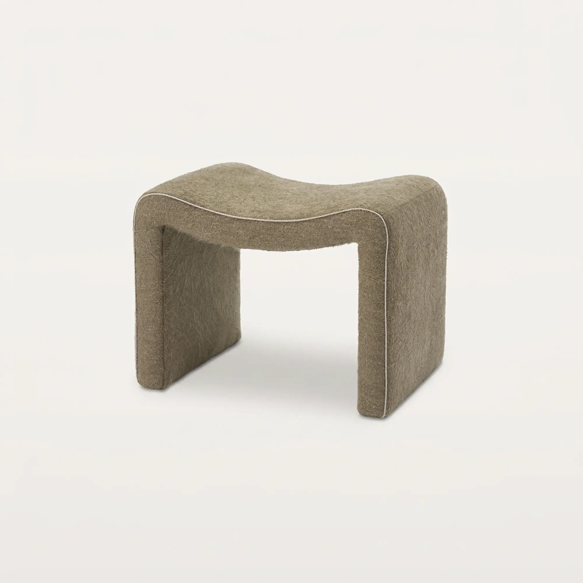 Sklar Furnishings Isla Ottoman in neutral fabric with piping detail.