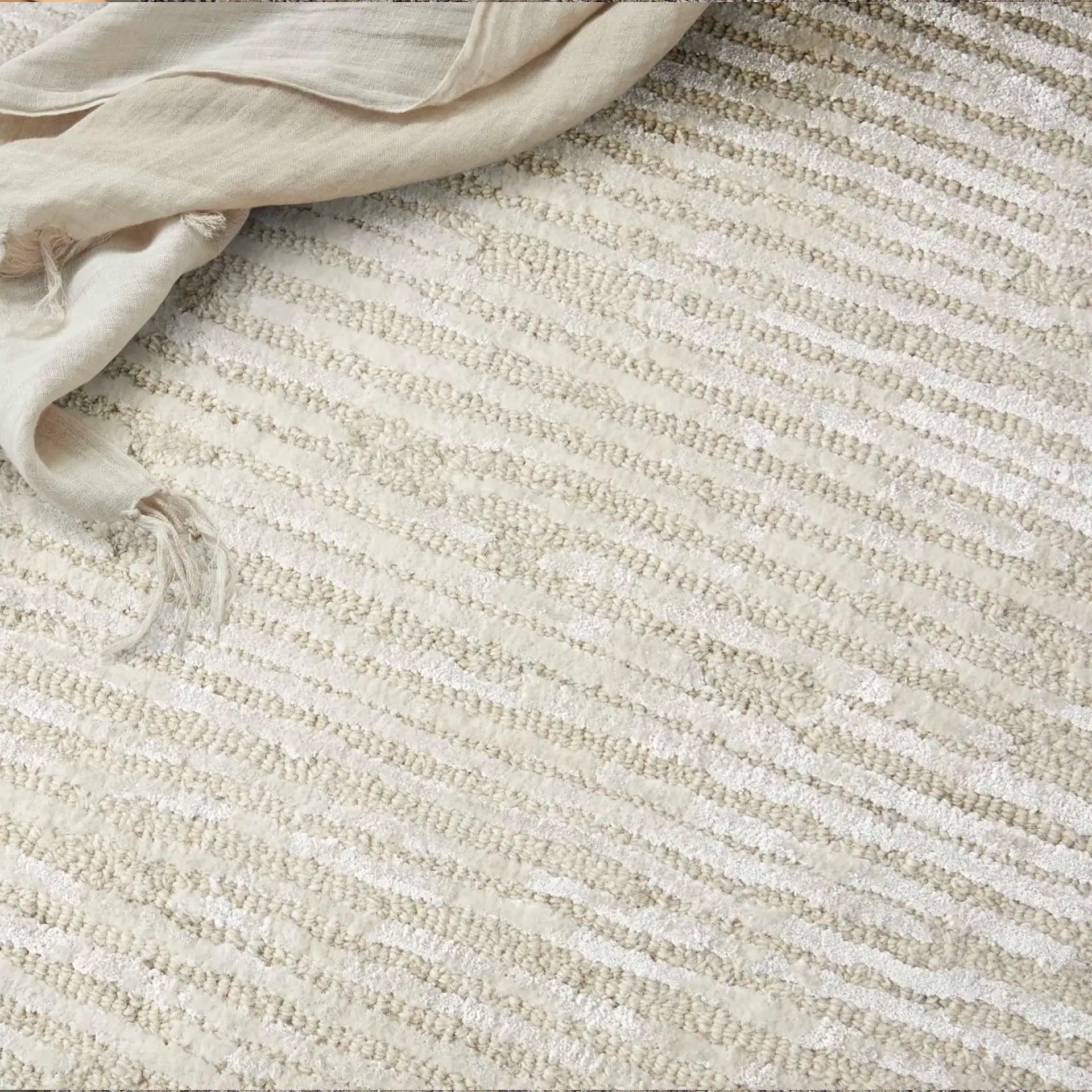 Sklar Furnishings rug with textured cream and beige stripes.