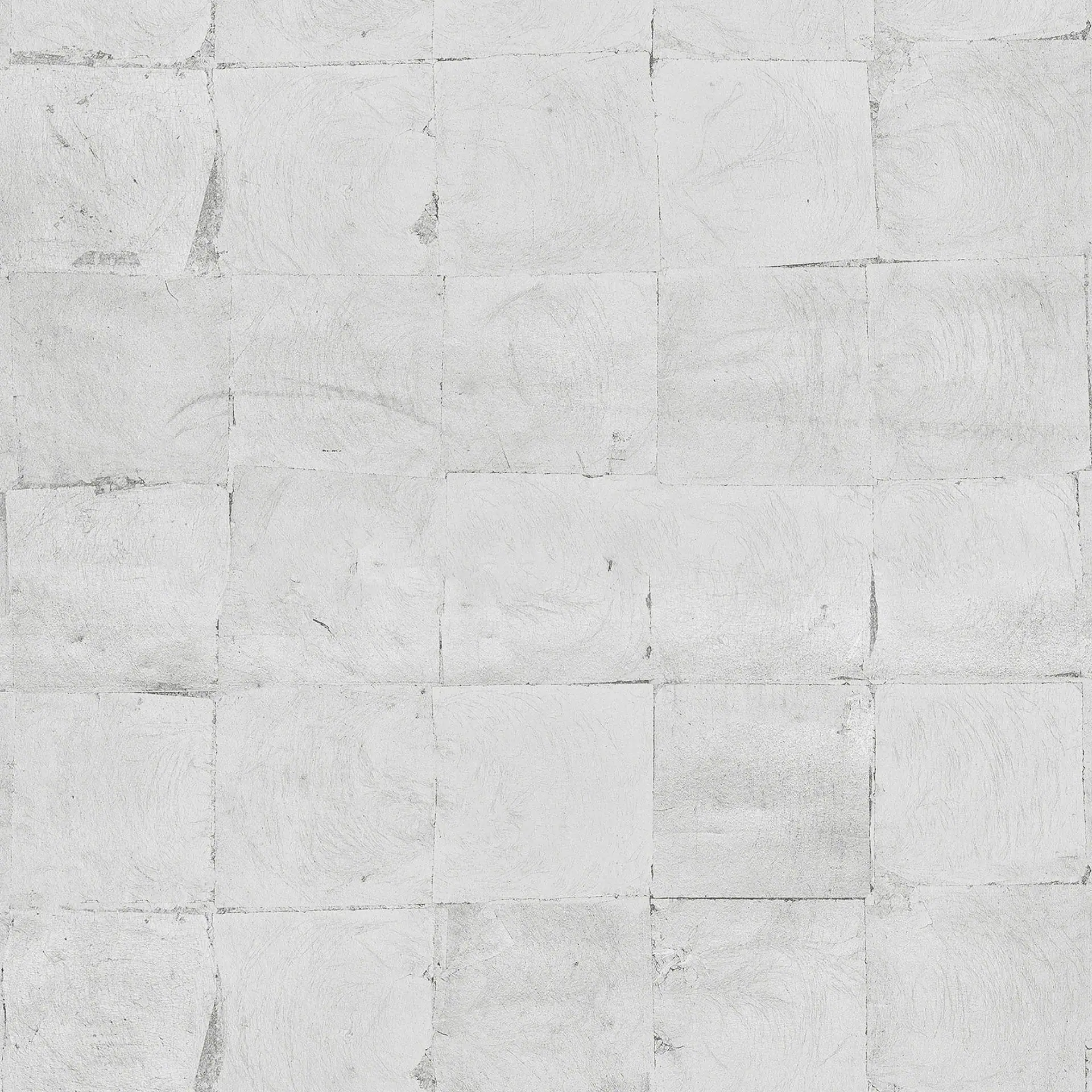 Close-up of white textured wall with subtle metallic leaf pattern.