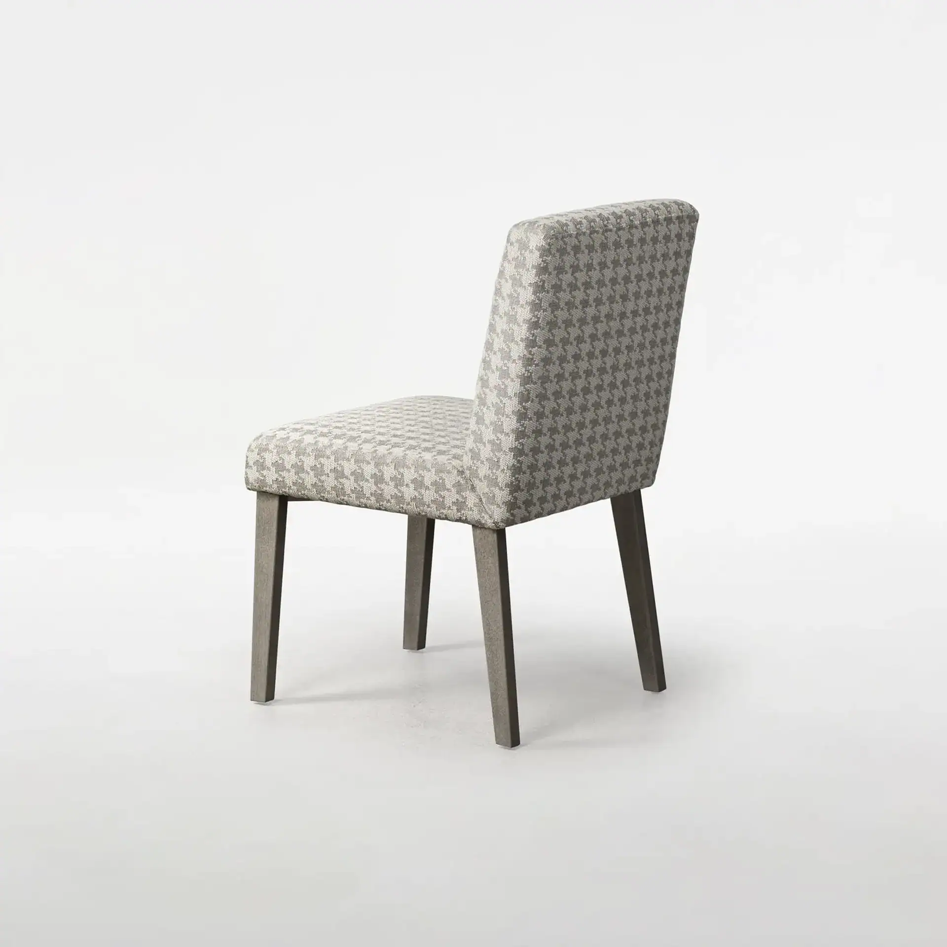 Dining chair with light gray and white houndstooth upholstery and dark gray wooden legs, viewed from a slight angle.