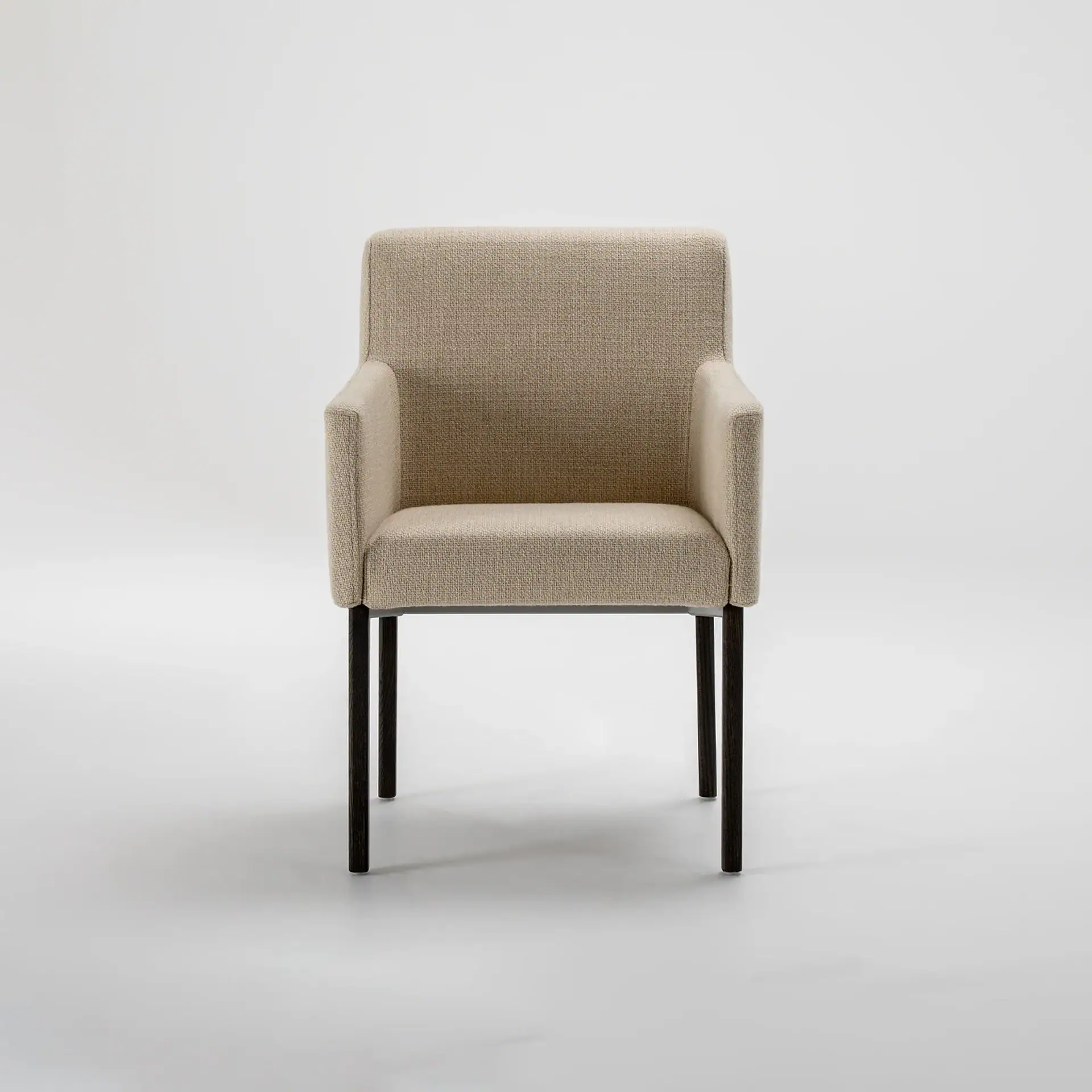 A modern dining chair with light beige textured fabric upholstery and dark wooden legs, set against a white background.