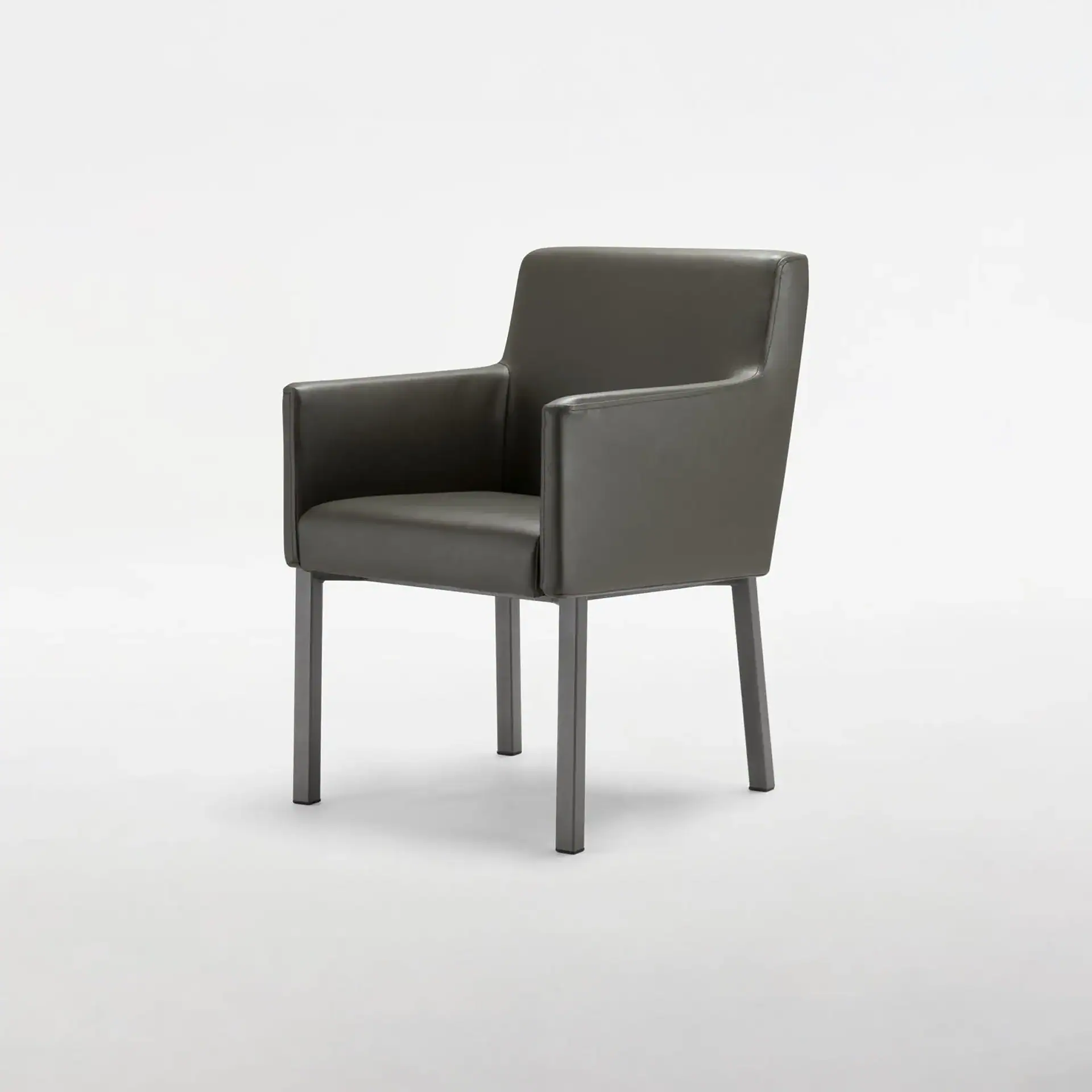 A dark gray upholstered armchair with metal legs on a white background.