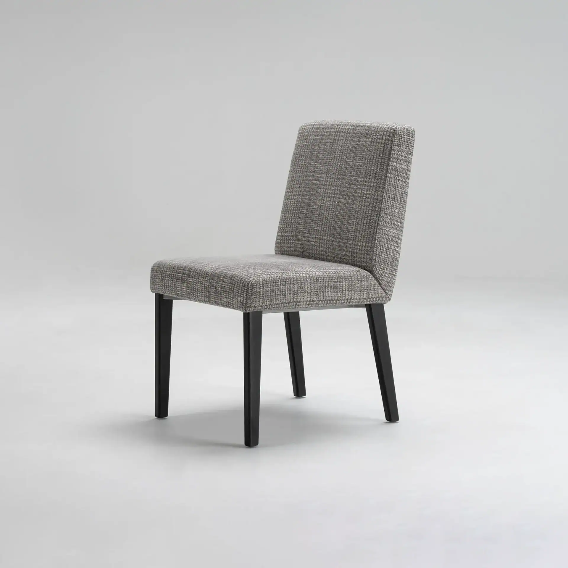 A gray upholstered dining chair with dark legs on a light gray background.