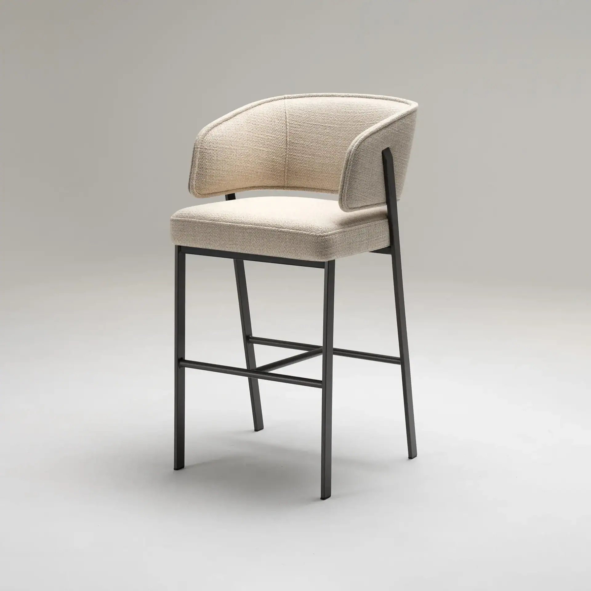 Sklar Furnishings Madison bar stool with beige upholstery and black metal frame.