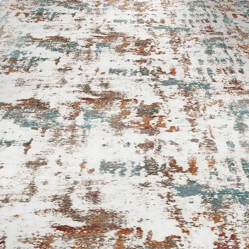 Abstract modern rug with distressed pattern in white, brown, and blue tones.