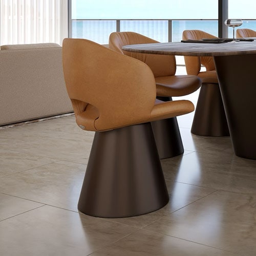 Sklar Furnishings modern dining chair with tan upholstery and black base.