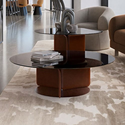Sklar Furnishings modern coffee table with black glass top and brown base in living room.