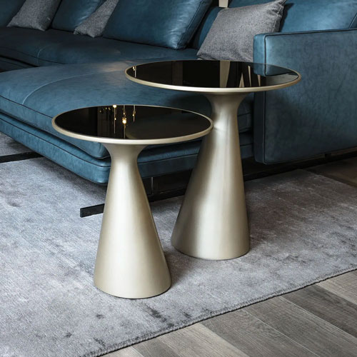 Sklar Furnishings modern side tables with black glass tops in a living room.