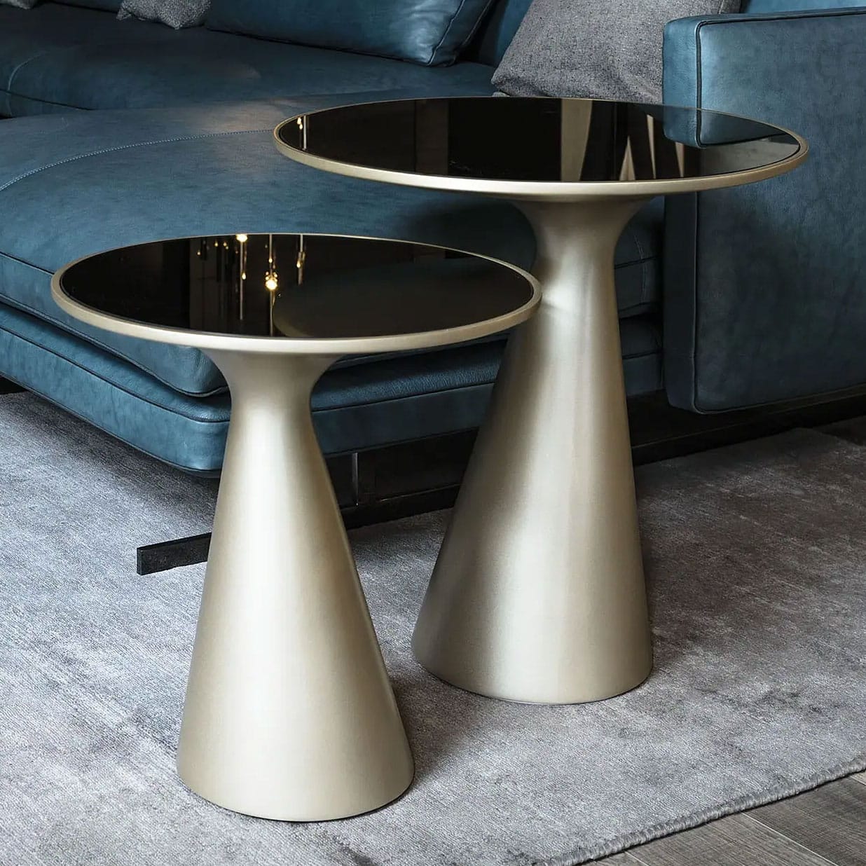 Sklar Furnishings modern side tables with black glass tops in a living room.