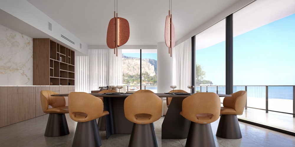 Modern dining room with six tan chairs and a black table overlooking the ocean.