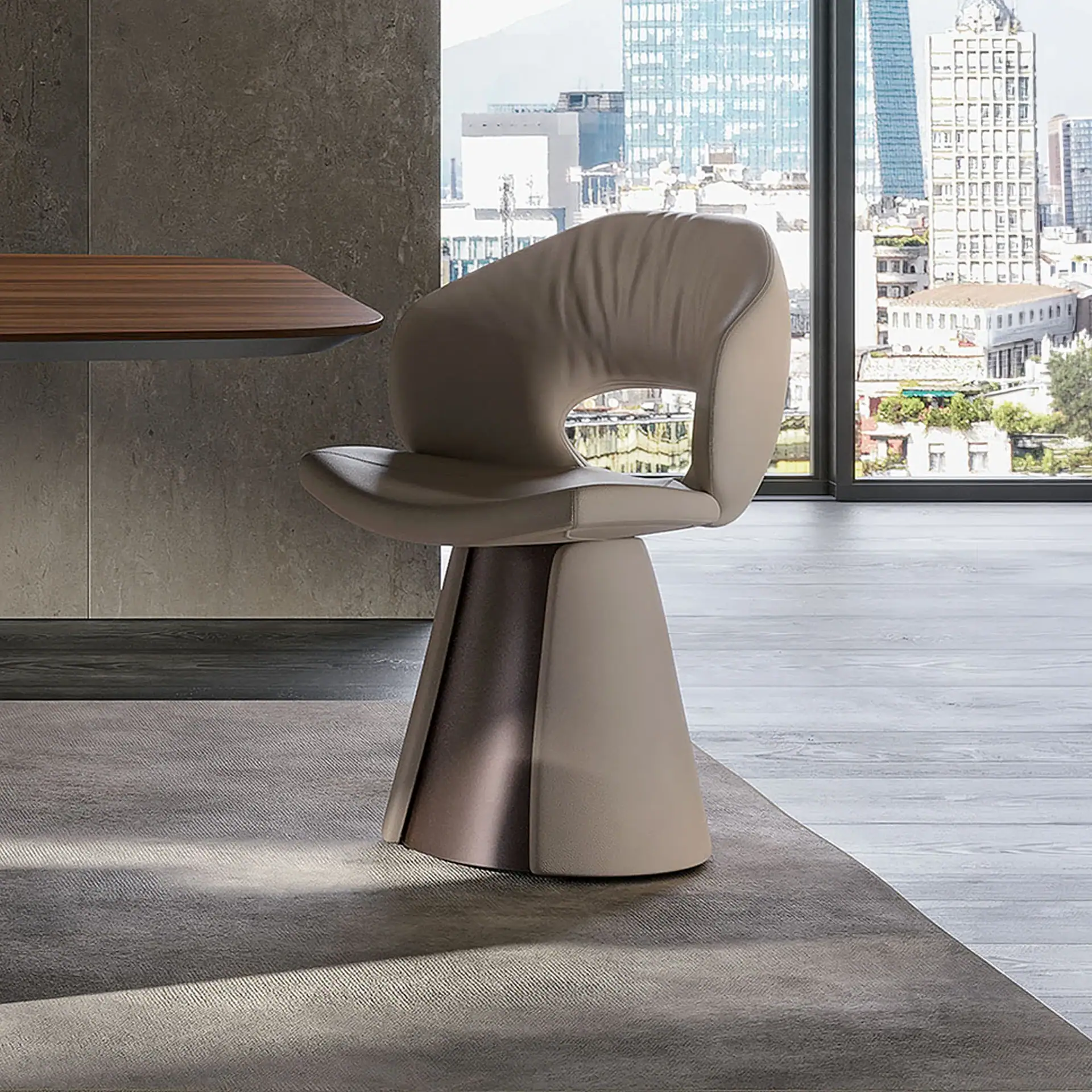 A modern, light beige upholstered chair with a sculptural two-tone base sits on a gray rug in a room with a large window overlooking a city skyline.
