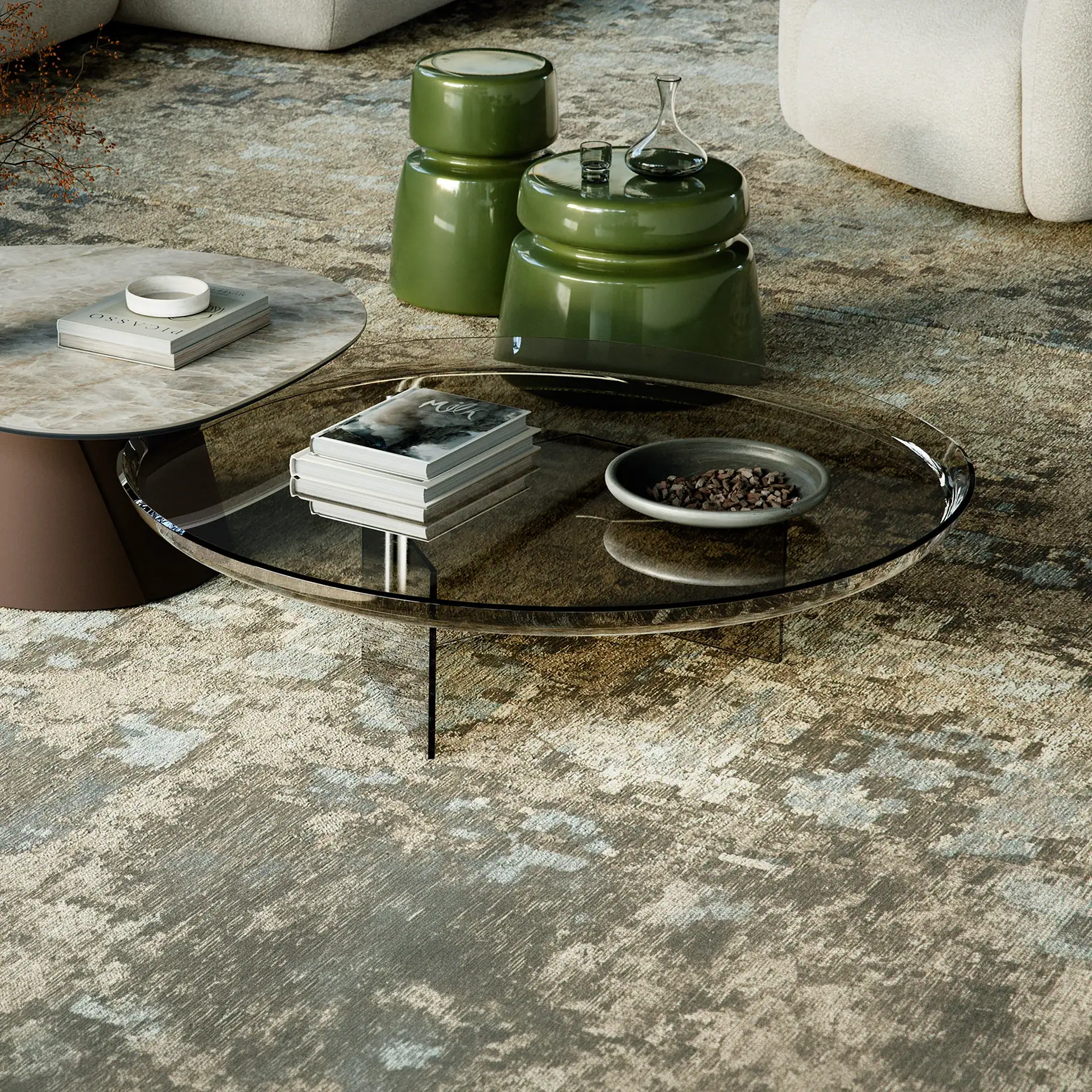 Modern living room with oval glass and round marble coffee tables, two olive green side tables, and a textured gray and beige rug.