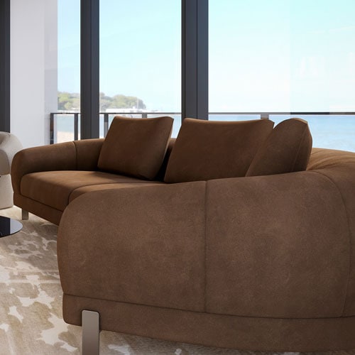 Sklar Furnishings brown sofa with cushions in a modern living room.