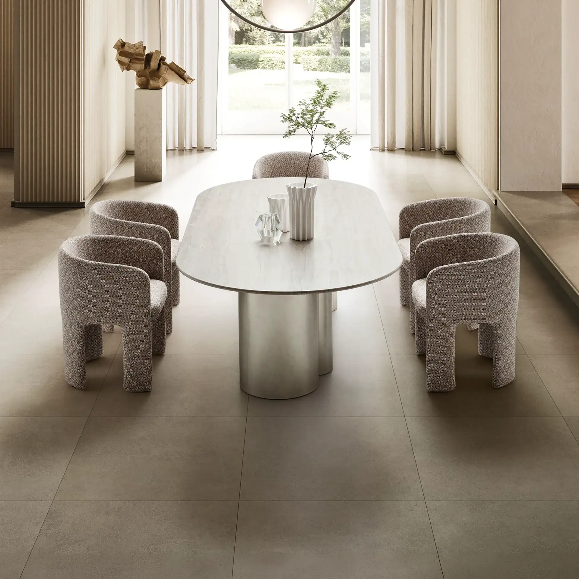 A modern dining room with an oval gray table, six textured beige chairs, and minimalist decor. Large windows overlook greenery.