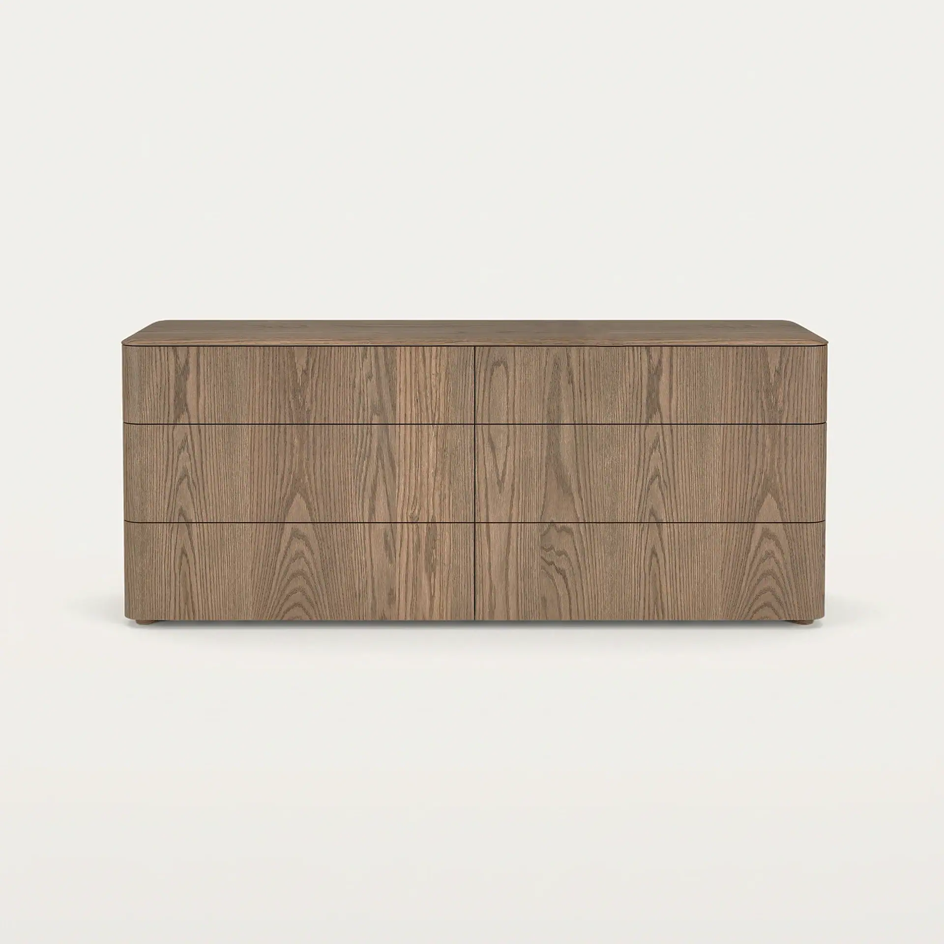 A modern six-drawer wooden dresser with rounded corners, a visible wood grain, and no visible handles, set against a light background.