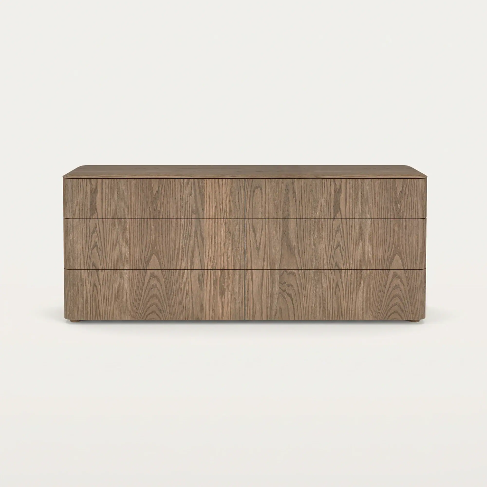 A modern six-drawer wooden dresser with rounded corners, a visible wood grain, and no visible handles, set against a light background.