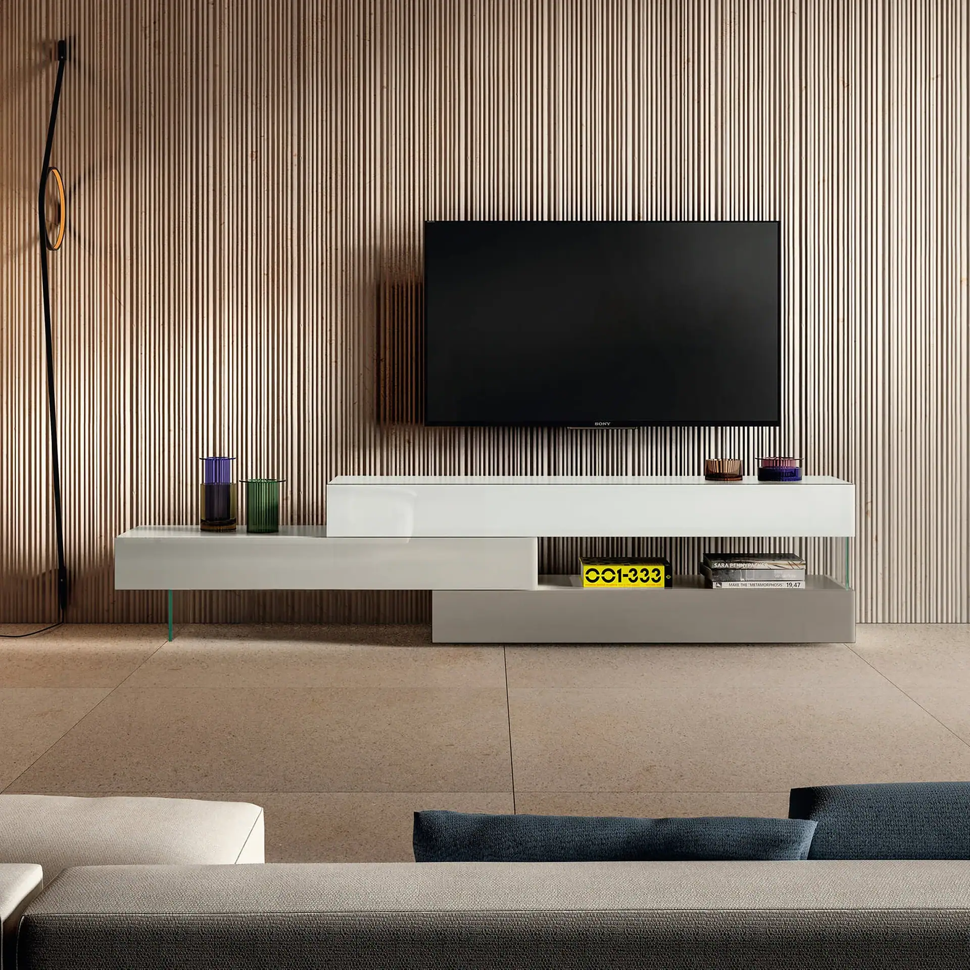 Modern TV console with decorative vases and books in a contemporary living room.