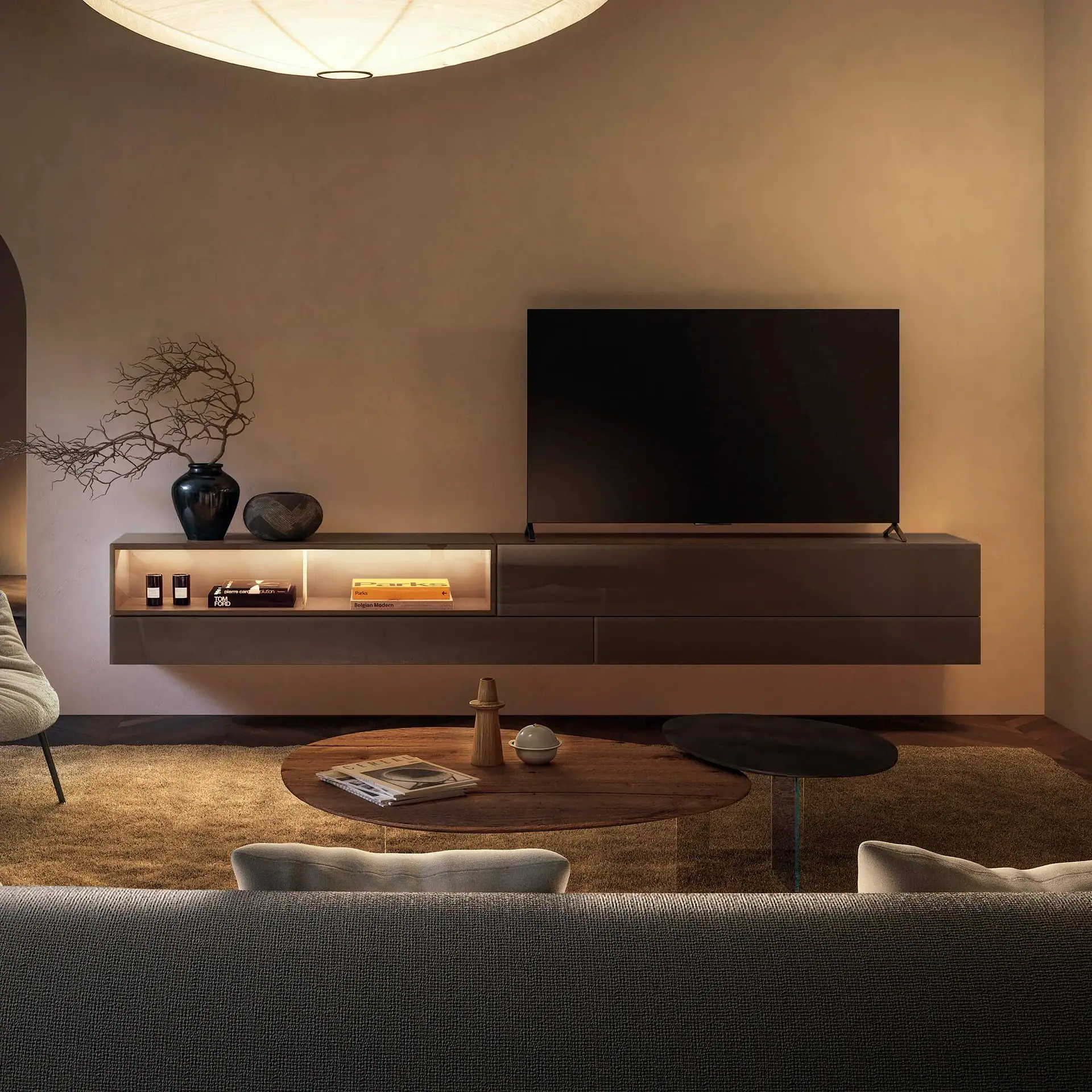 Sklar Furnishings TV console with mounted TV and decorative accessories.