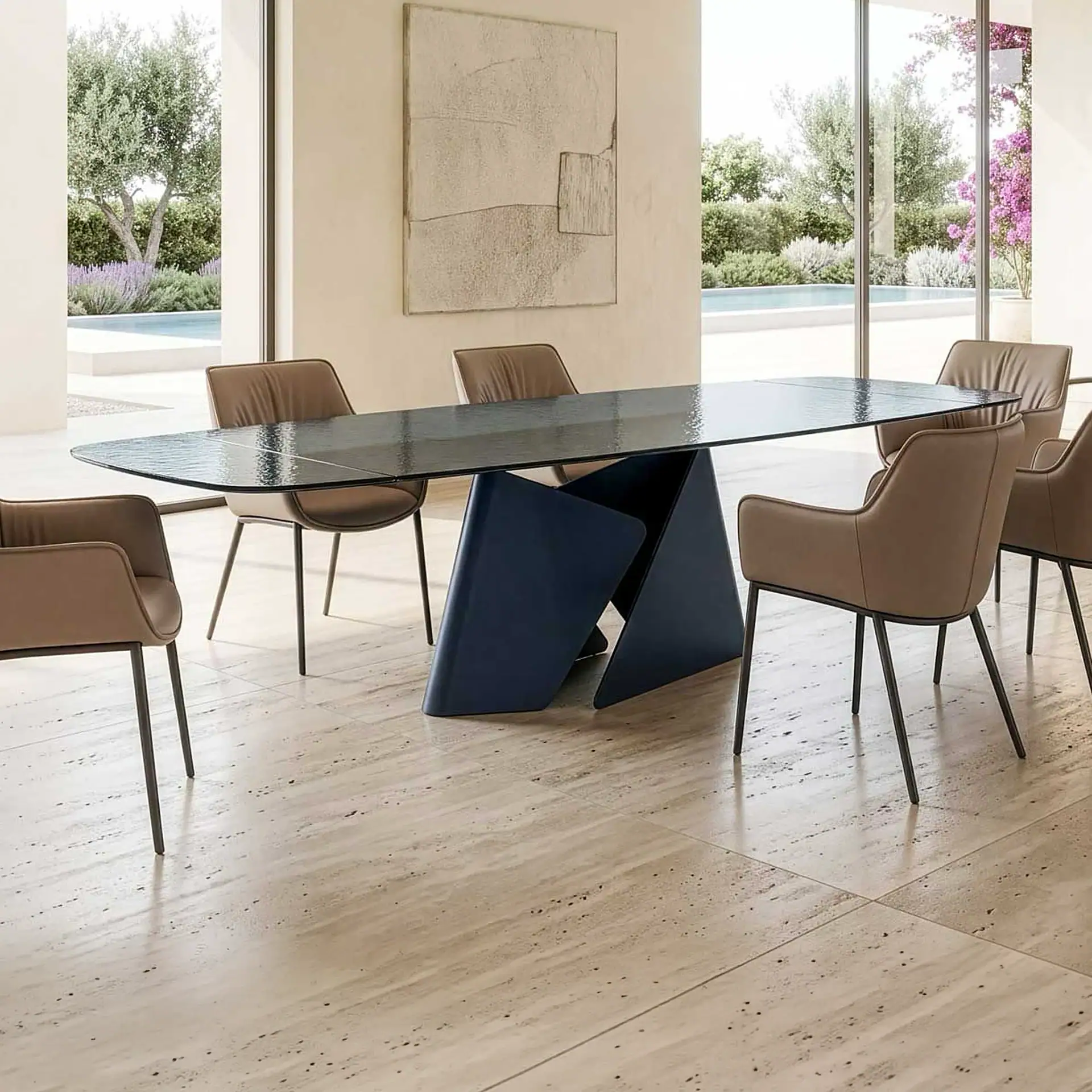 A modern dining room with an oval dark-topped table, a dark blue geometric base, and six light brown leather chairs. Large windows overlook a swimming pool, green trees, and lavender bushes.