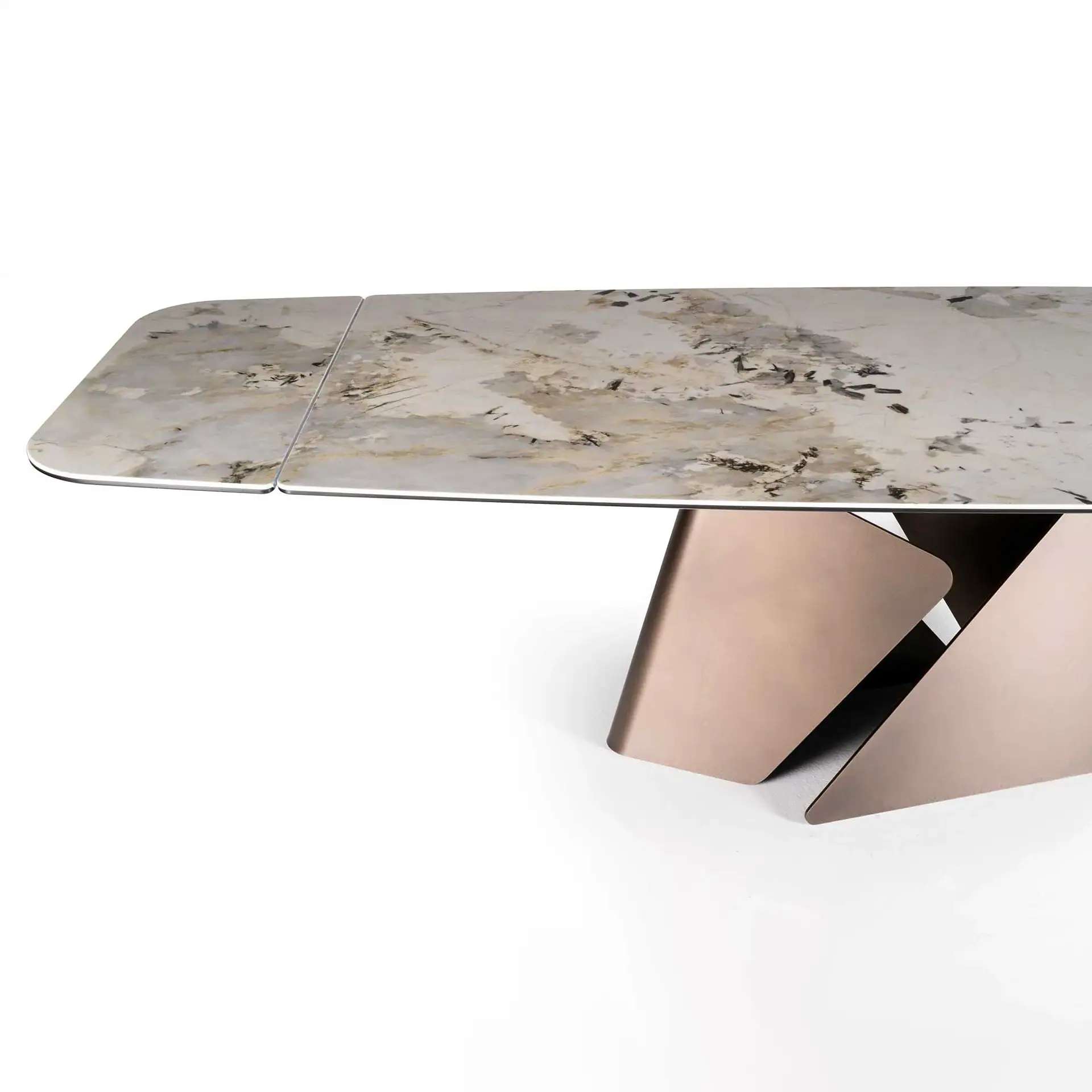 A modern dining table with a light marble-patterned top and a sculptural, angular rose gold metallic base, set against a white background.