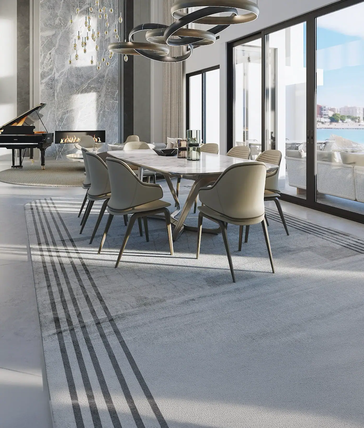 our core values inspire excellence 1.2 | Sklar Furnishings A luxurious open-concept dining and living room with a marble dining table, beige chairs, a fireplace, and a grand piano, opening to a waterfront view.