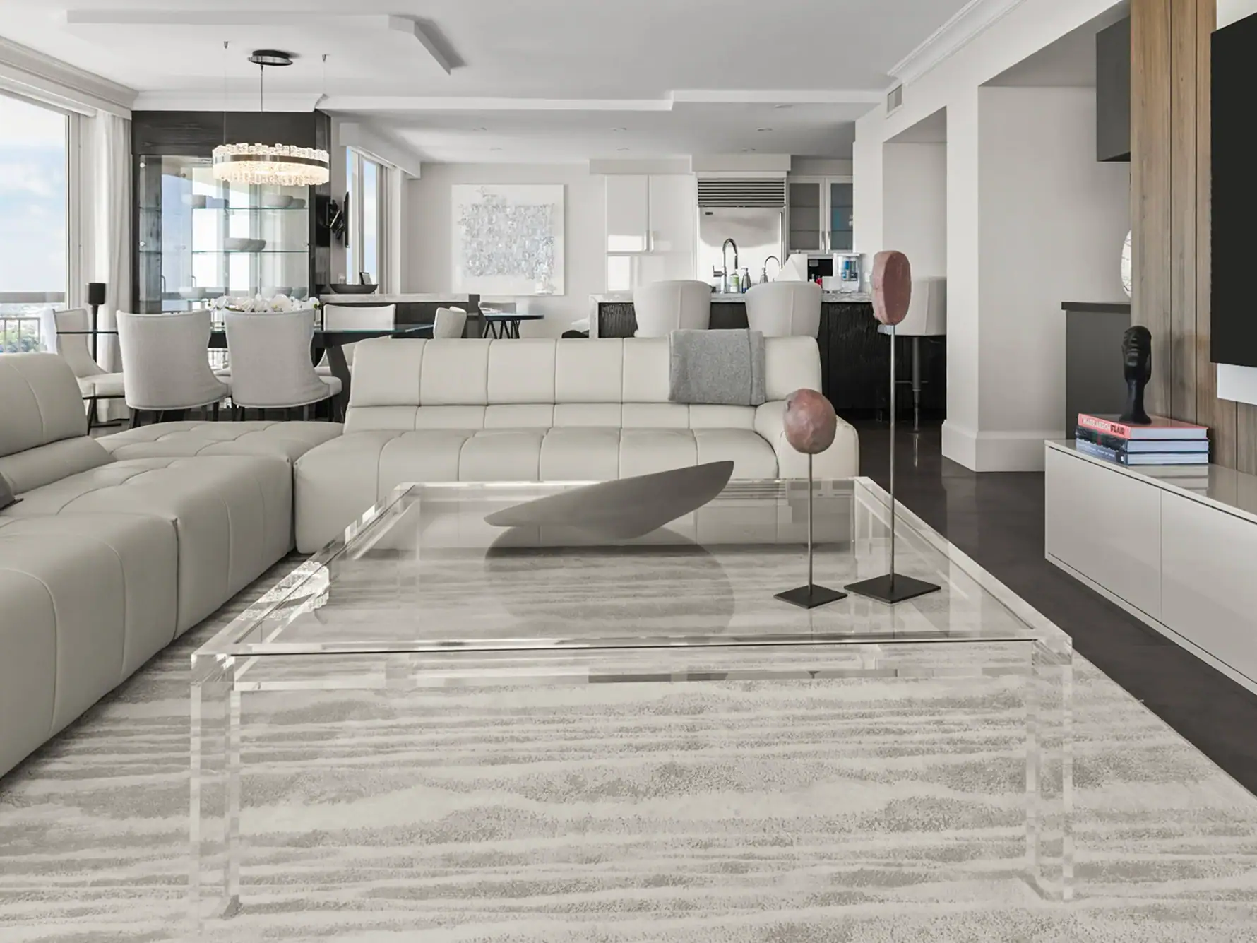 our core values inspire excellence 1.5 | Sklar Furnishings A luxurious dining room with a marble table and eight beige chairs on a striped rug, a grand piano, a fireplace, and glass doors opening to a sea view.