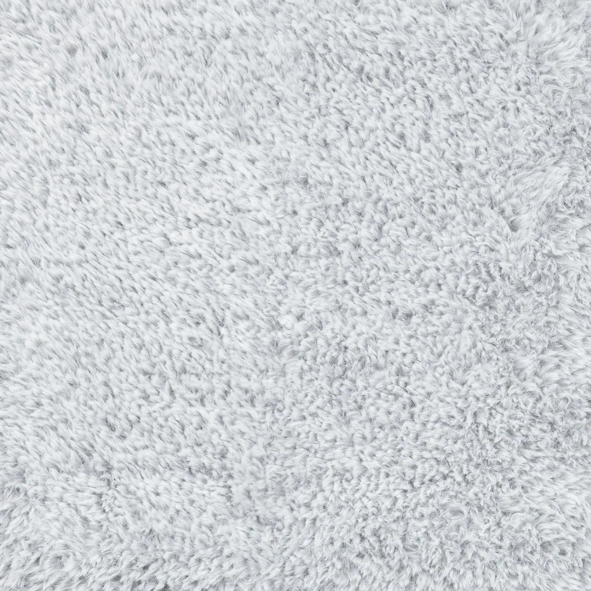 Close-up of a light gray, fluffy, and textured material, resembling faux fur or a shaggy carpet.