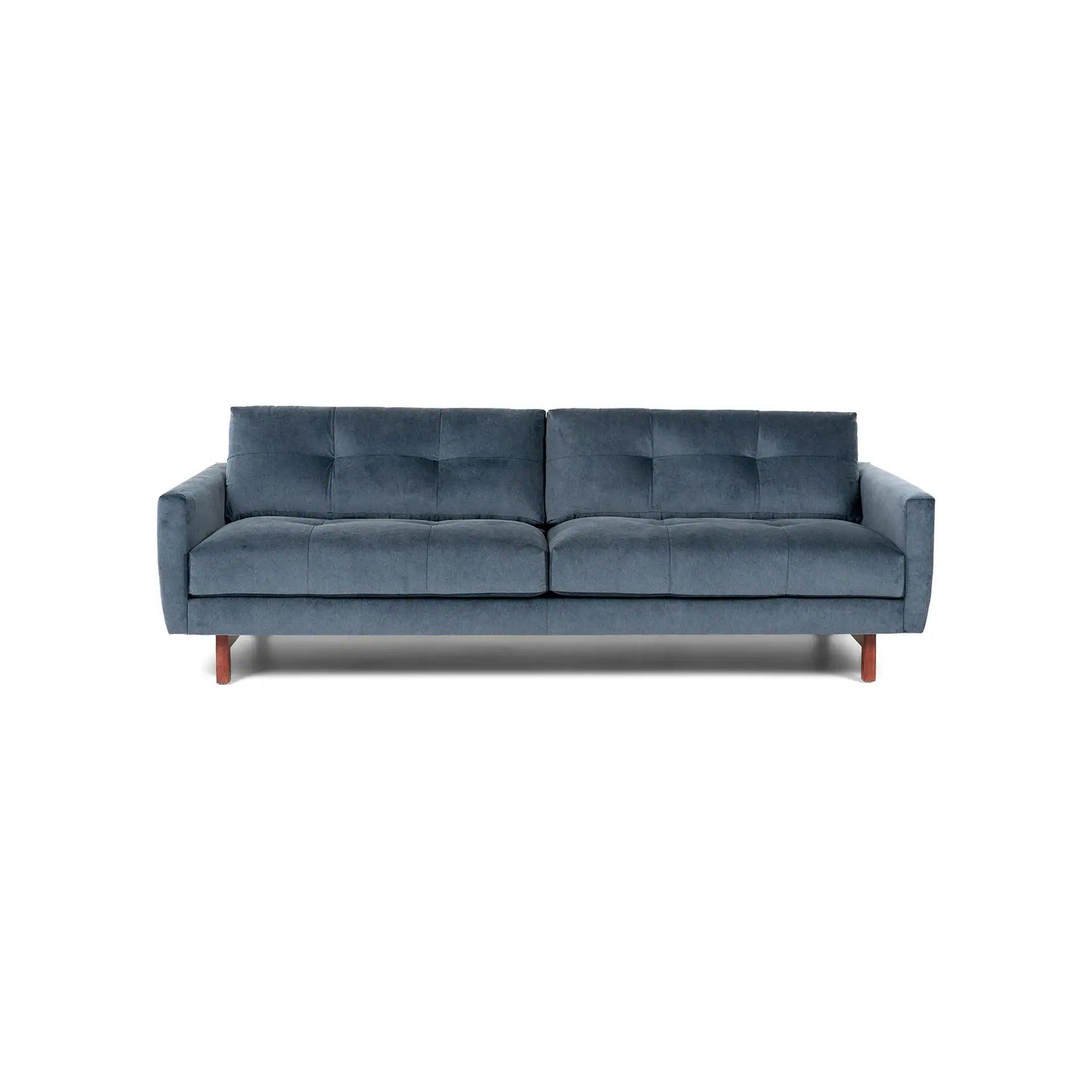 Front view of a modern two-seater sofa in dark blue-gray velvet with tufted cushions and short wooden legs, on a white background.