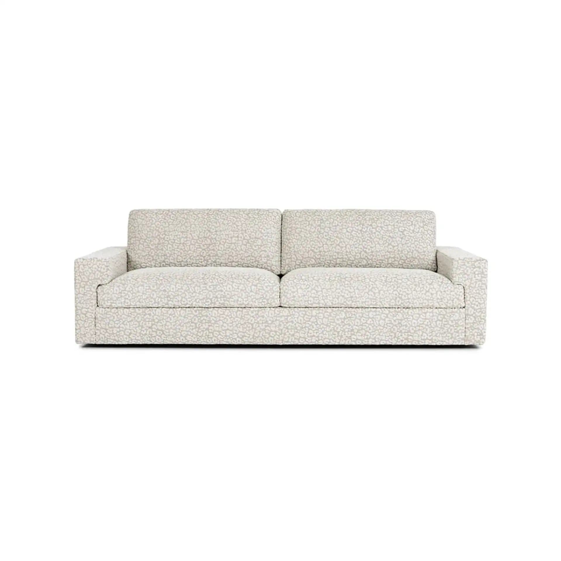 A modern sofa upholstered in a light grey and white leopard print fabric.