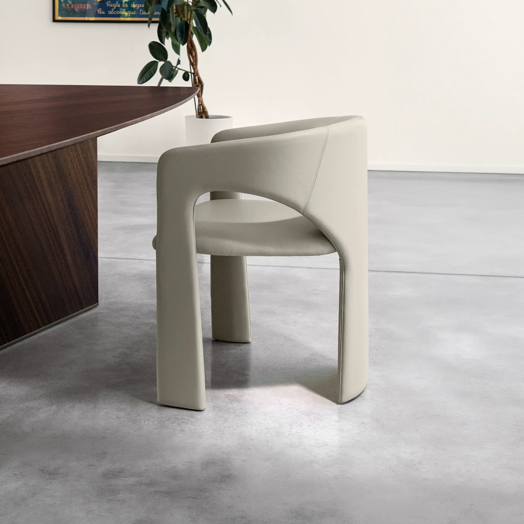 Sklar Furnishings chair in light grey with sculptural curved arms and solid legs.