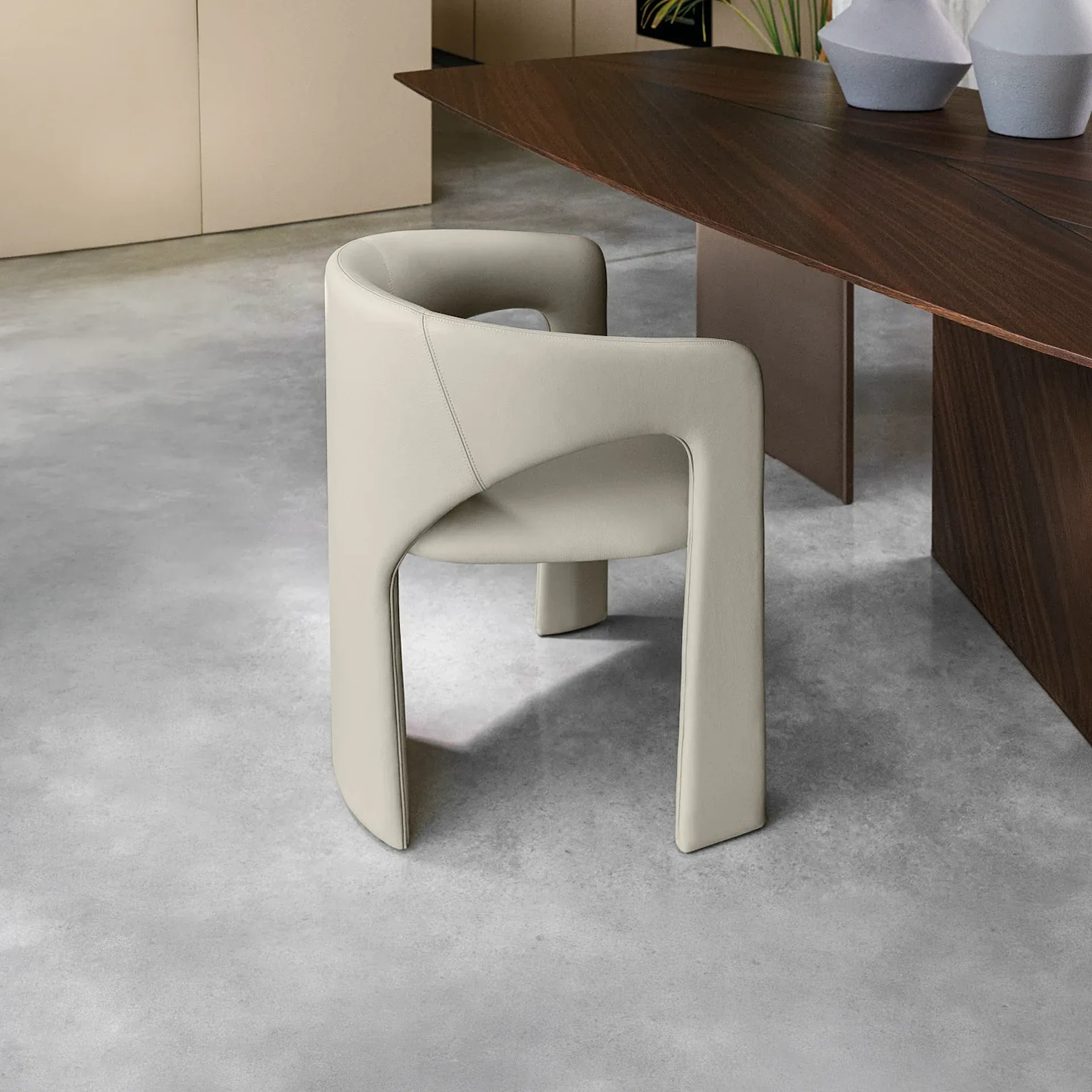 Sklar Furnishings chair design in neutral upholstery by table.