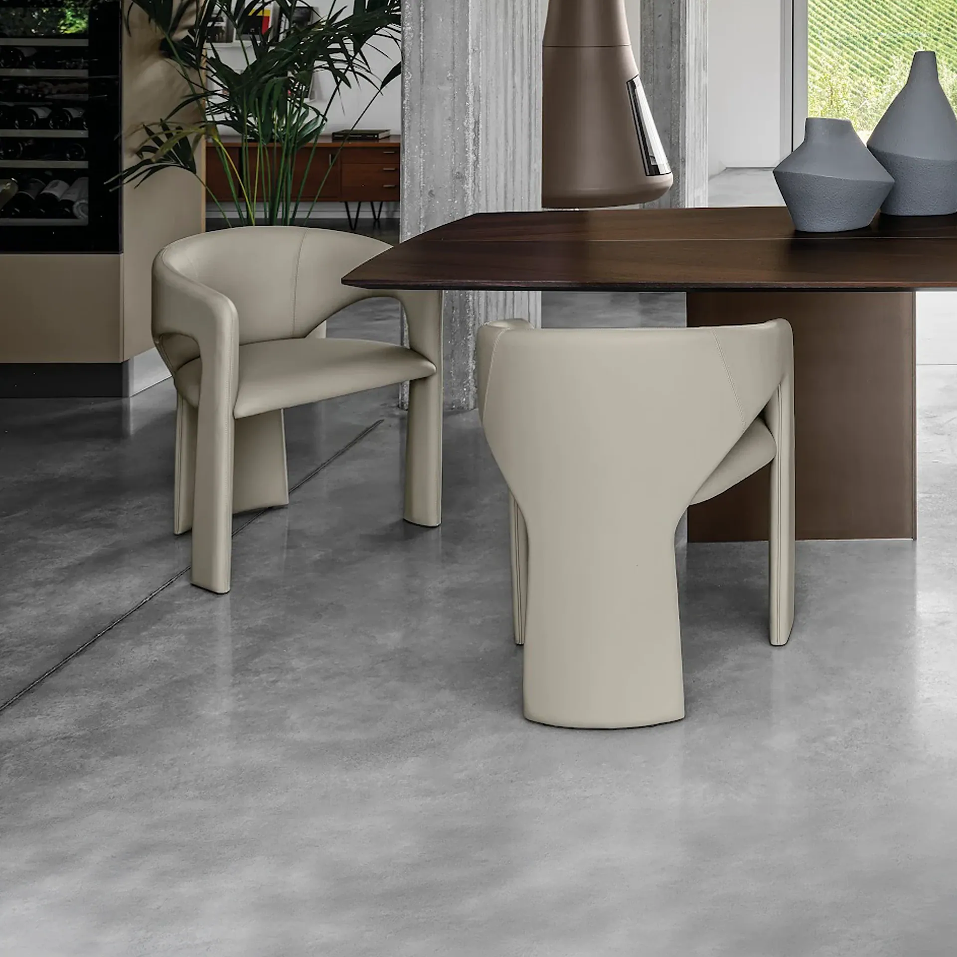 Sklar Furnishings Sienna Dining Chair in cream with curved arms by table.