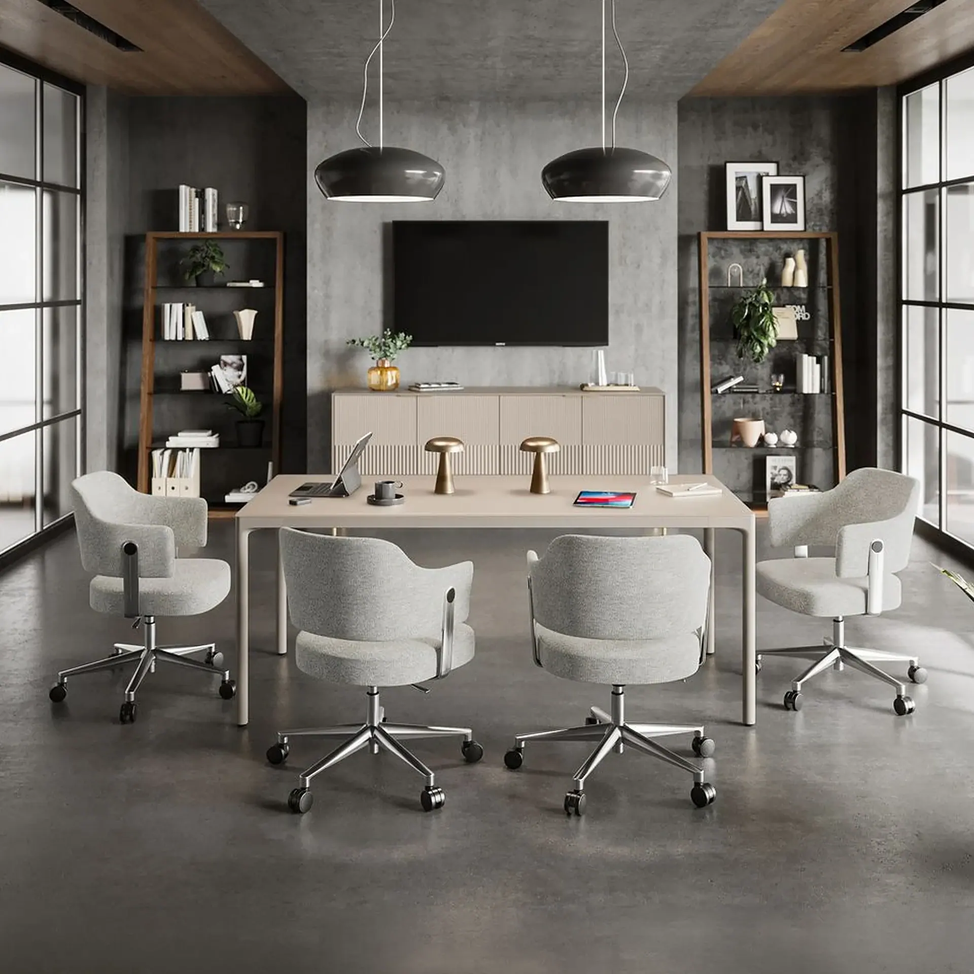 A modern meeting room with a light-colored table, four gray office chairs, a TV, and two bookshelves against dark gray walls and a wooden ceiling.