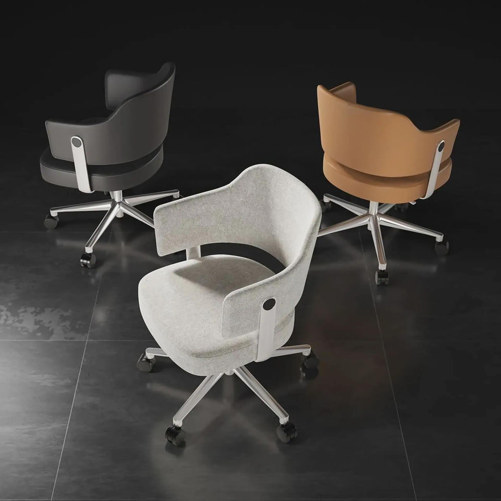 Three modern office chairs in light grey fabric, dark grey leather, and tan leather, arranged on a dark tiled floor.