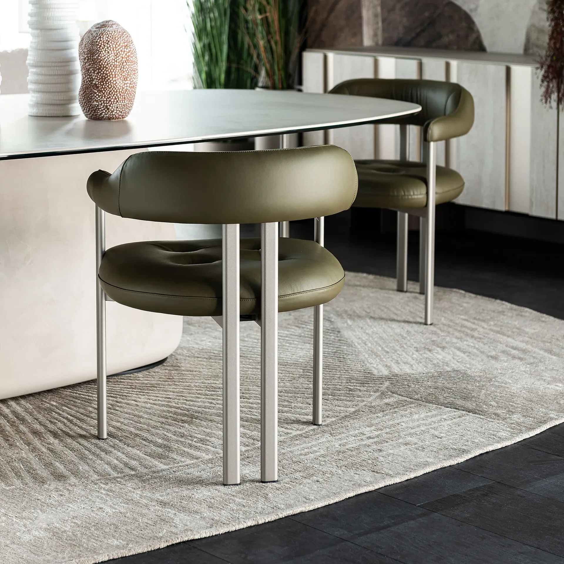Sklar Furnishings armchair with olive upholstery and metal legs in dining room.