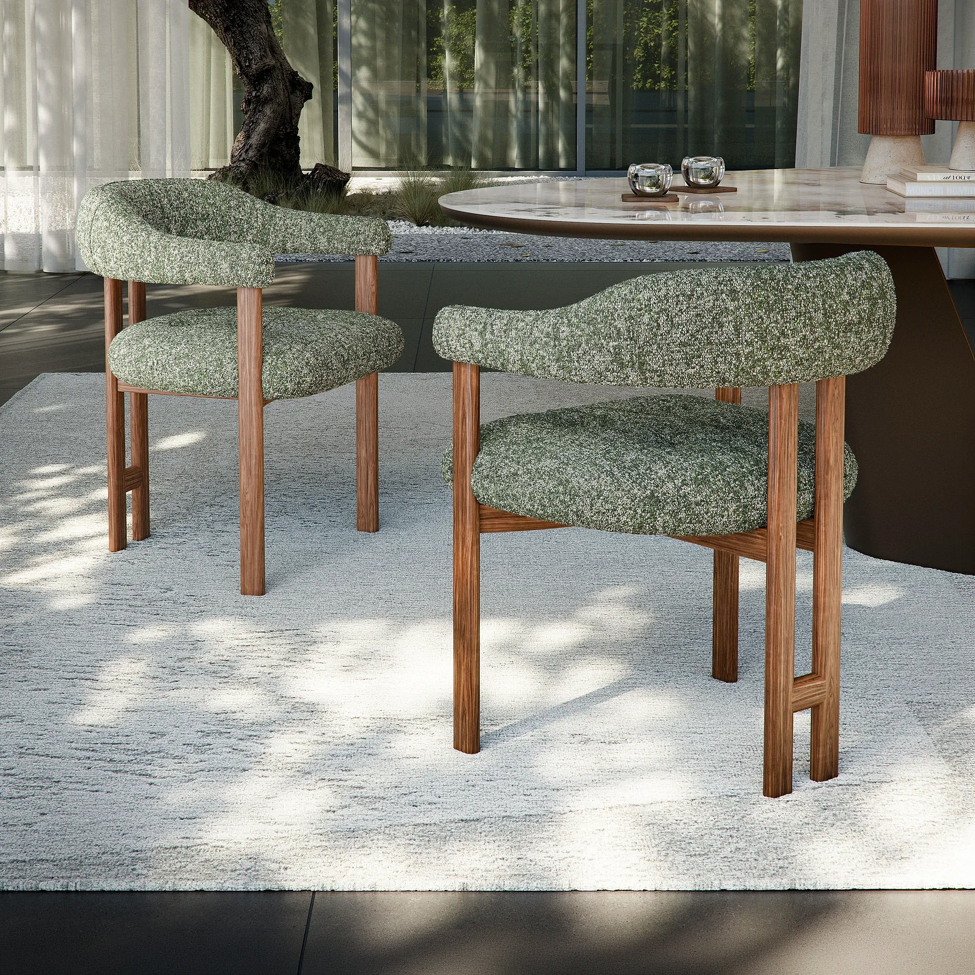 Greta dining armchair pair outdoors with green upholstery and wooden legs.