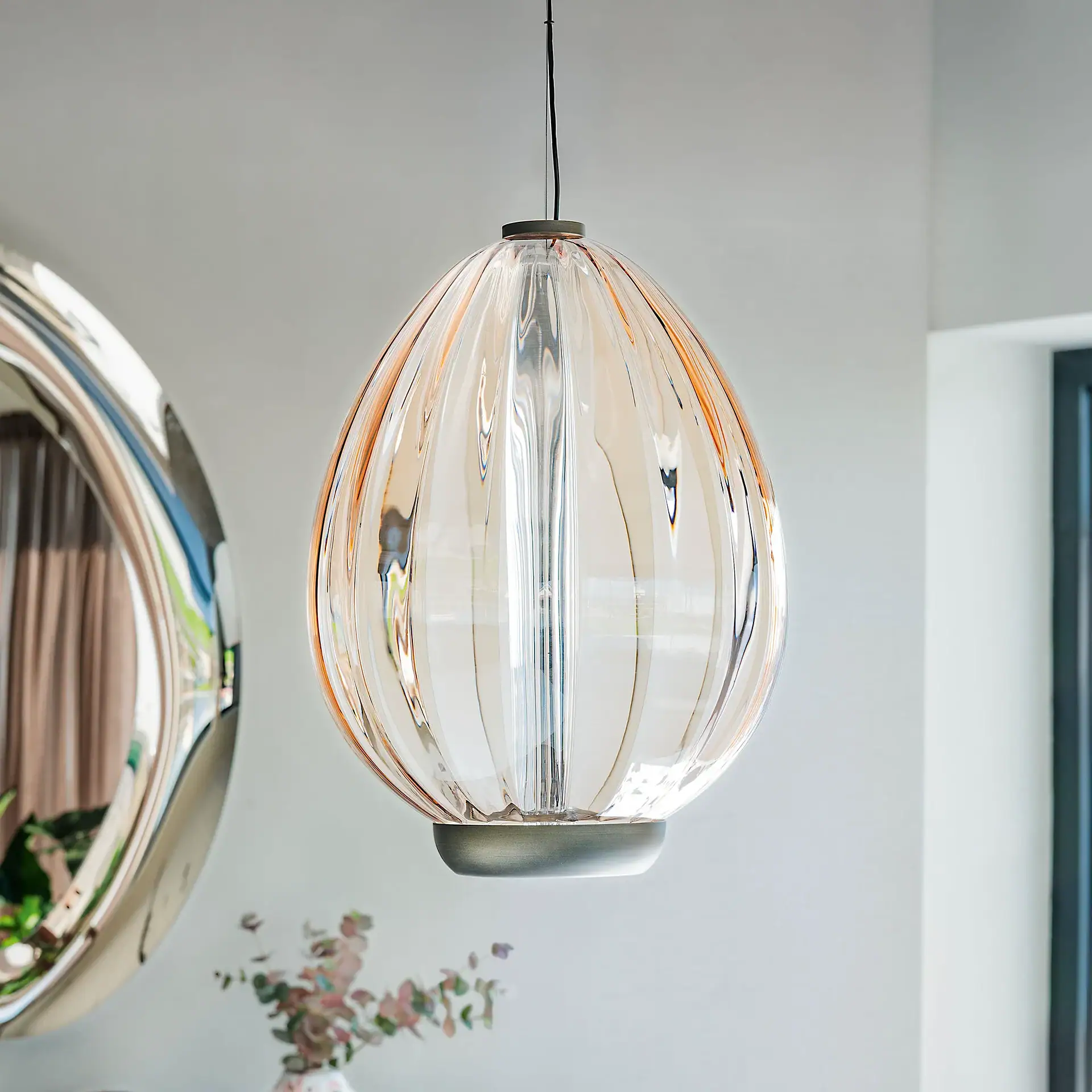 Sklar pendant light hanging in living space.