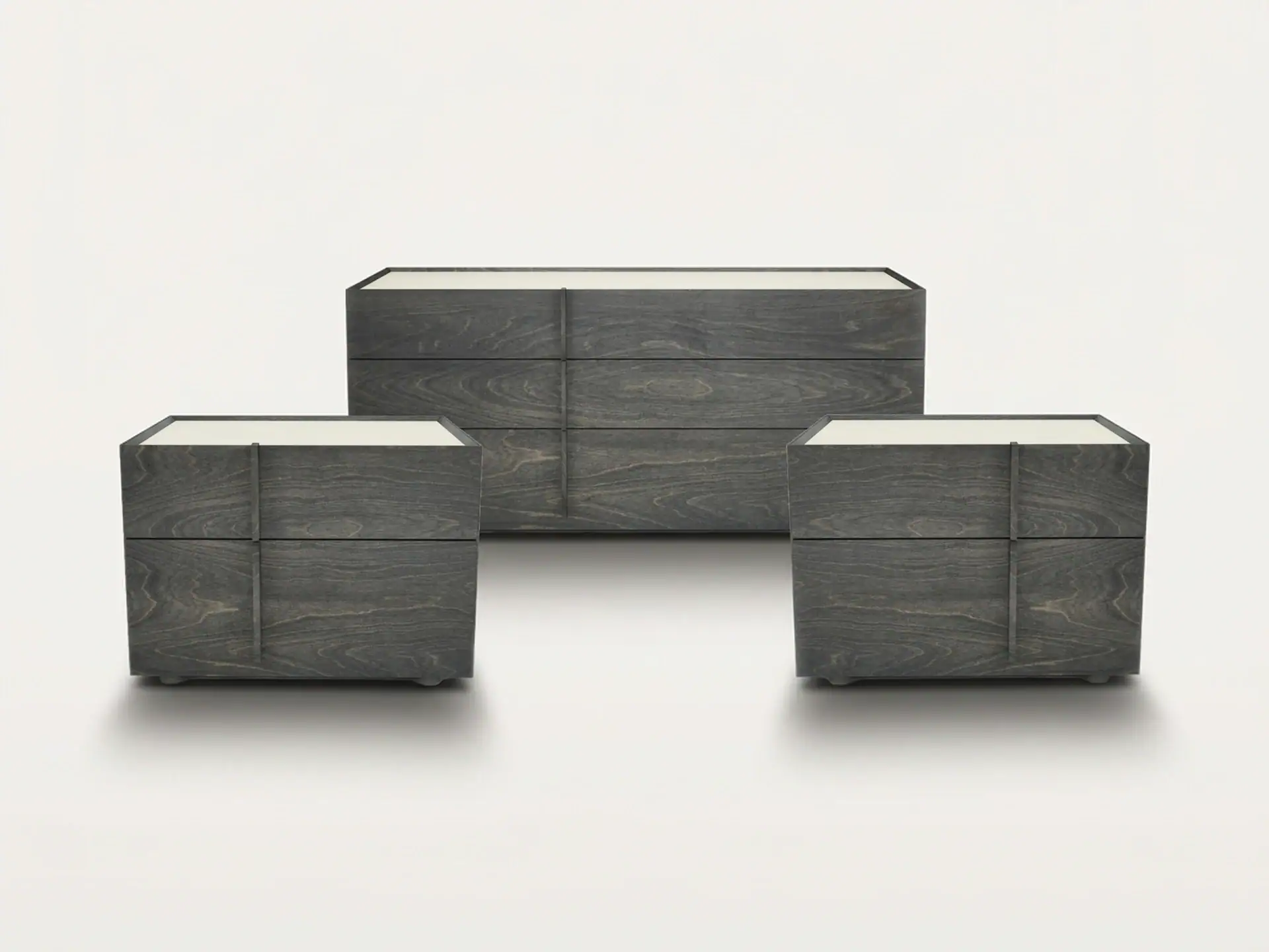 A set of three dark gray wooden furniture pieces: a long dresser in the back and two smaller nightstands in the front, all with light-colored tops, arranged on a light gray background.