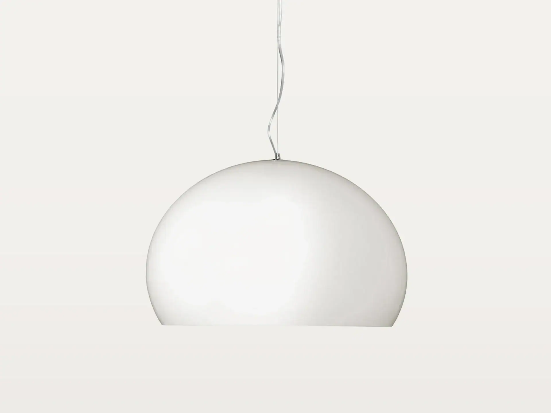 A white, semi-spherical pendant light hangs against a light background.
