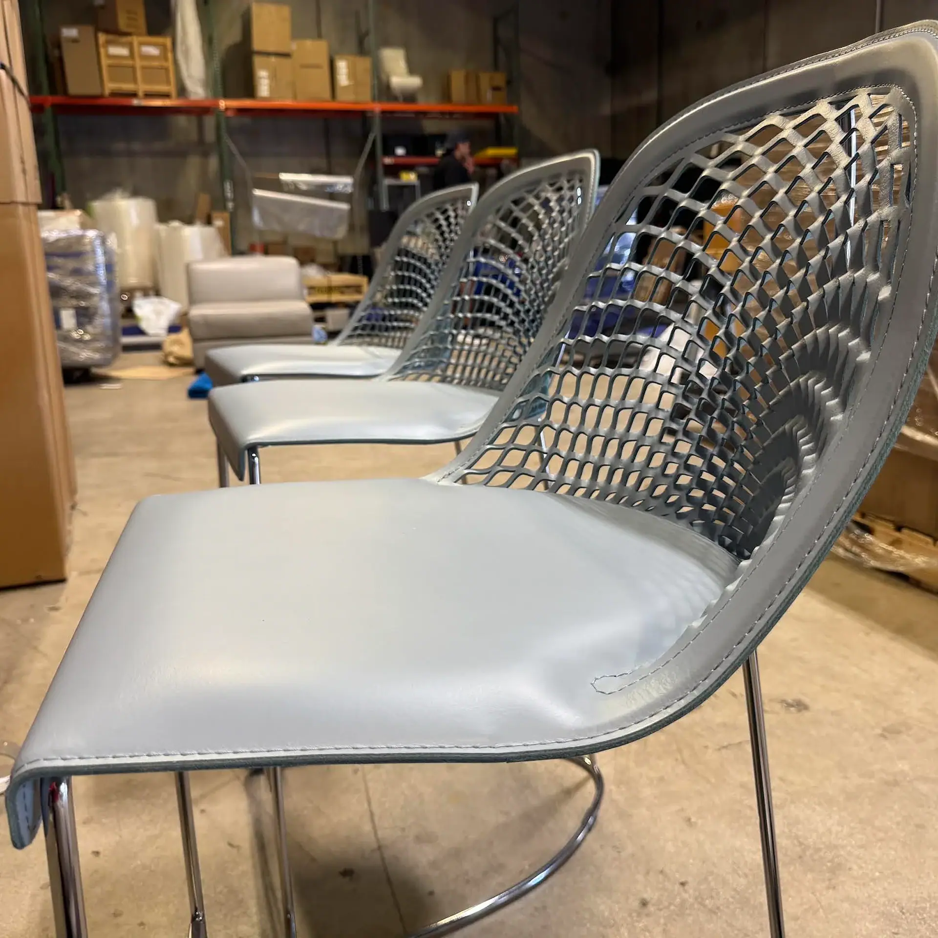 Sklar Guapa Counter Stool in row in warehouse.