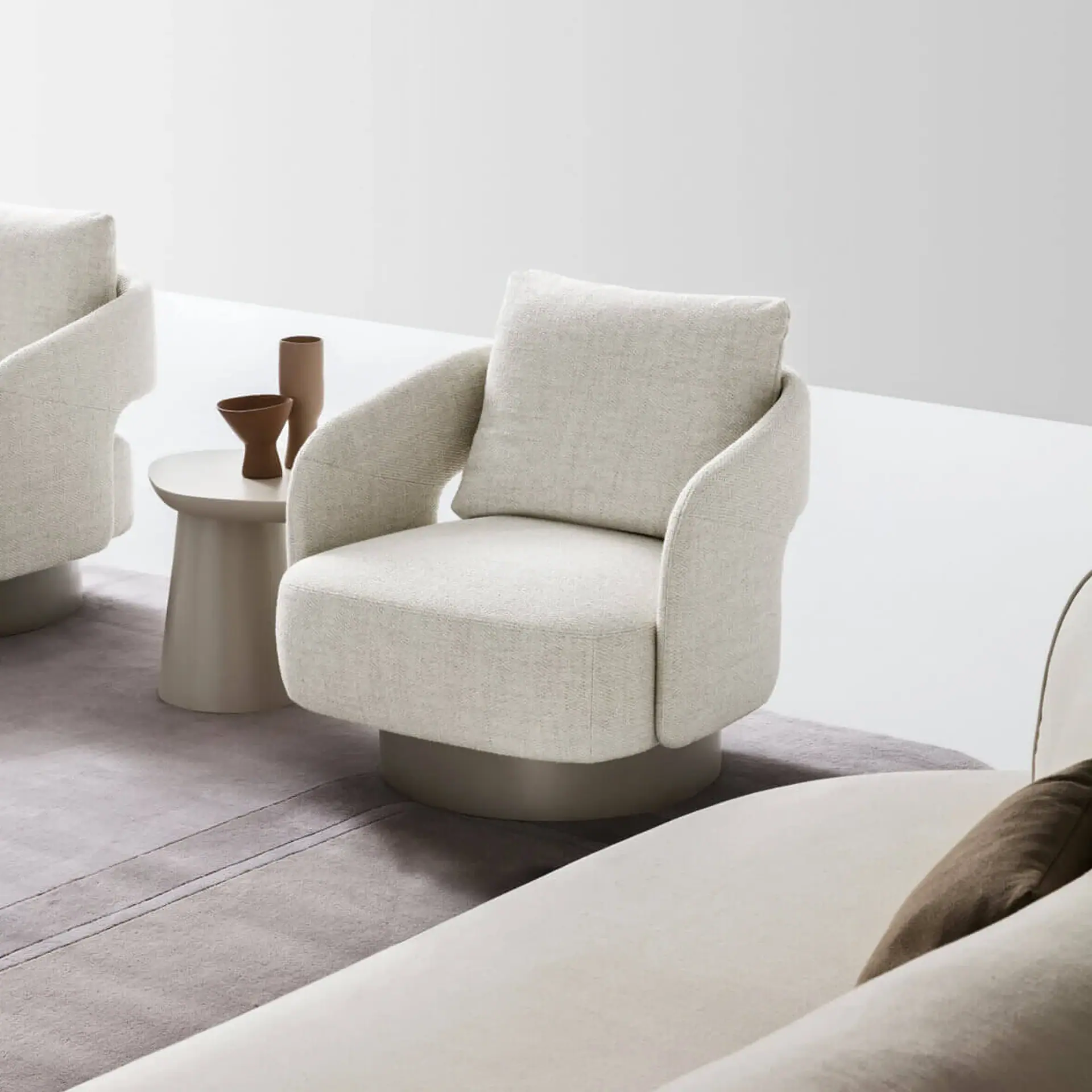 Sklar Furnishings armchair in light beige with matching neighboring pieces.