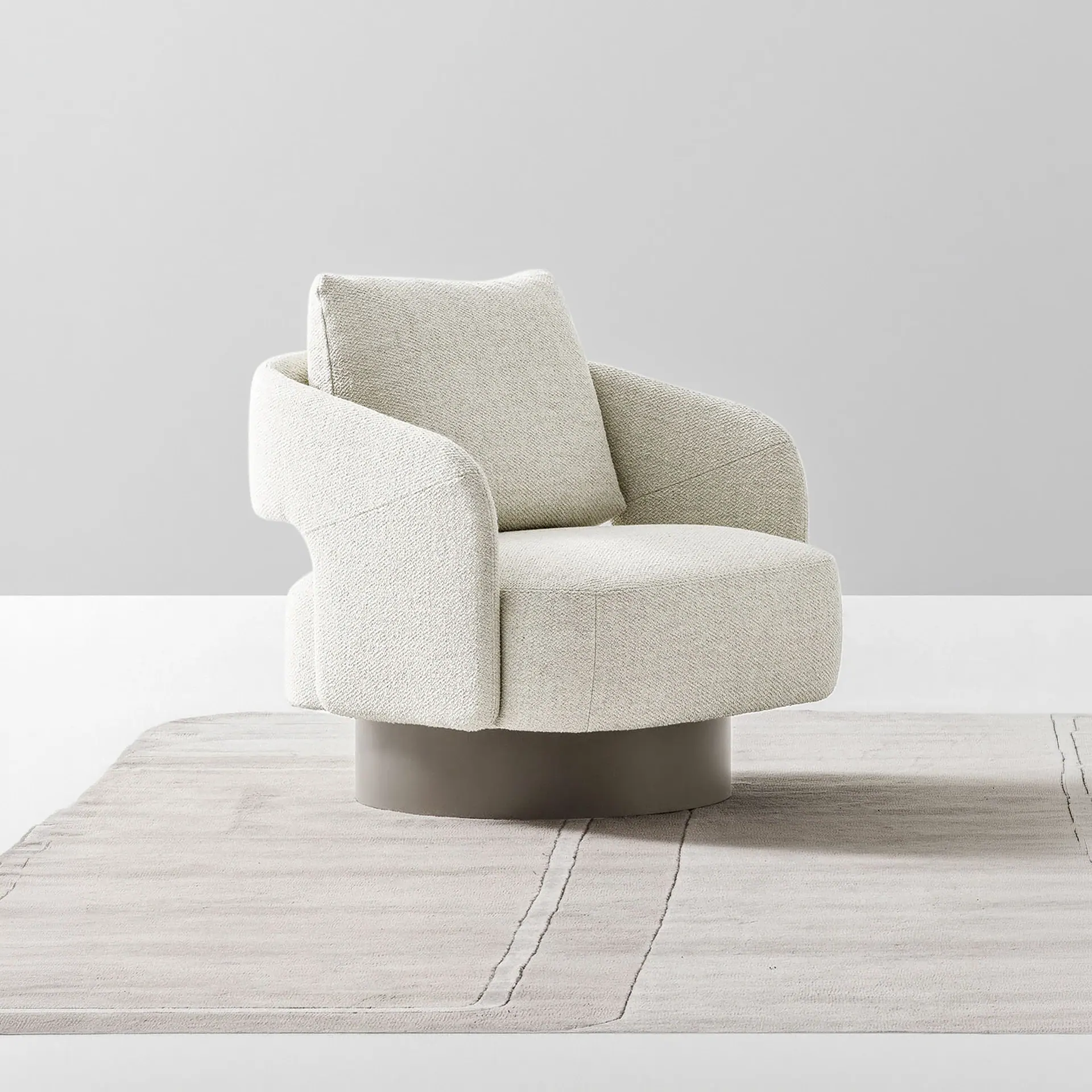 Armchair with light beige fabric and rounded arms in a bright, minimal setting.