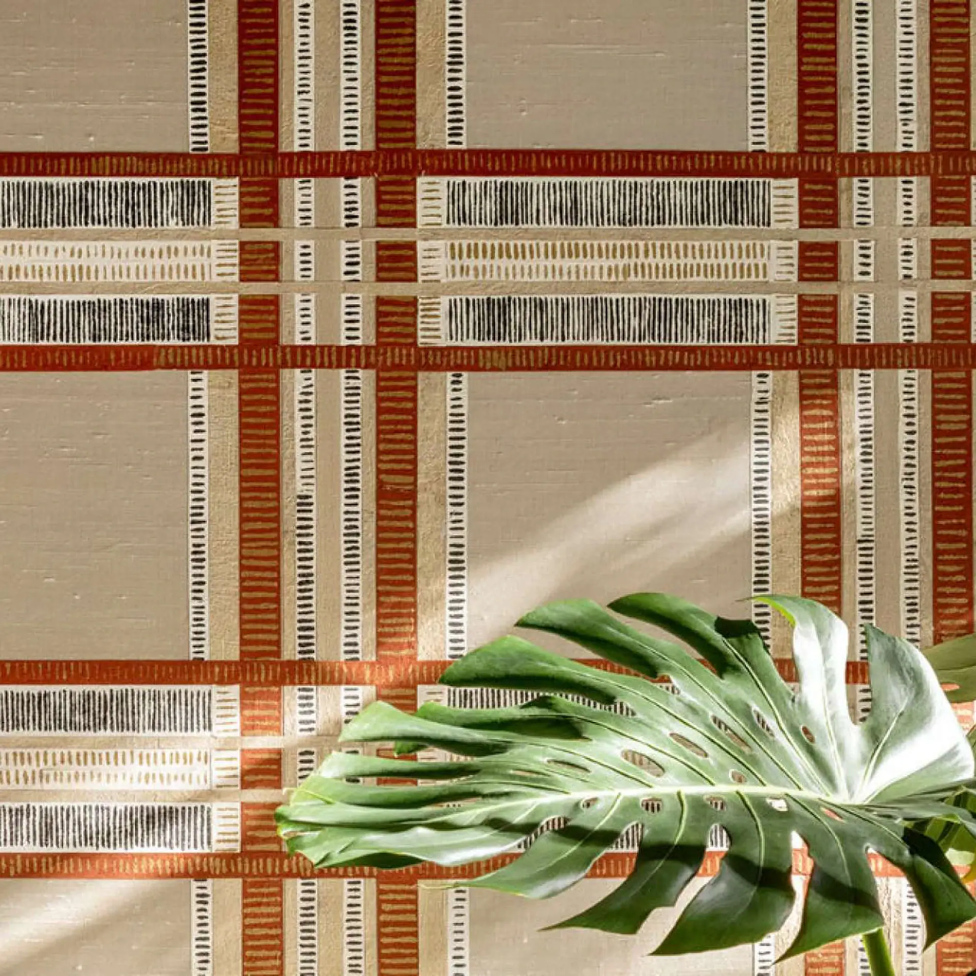 Shiraz wallpaper pattern with geometric lines and warm tones.