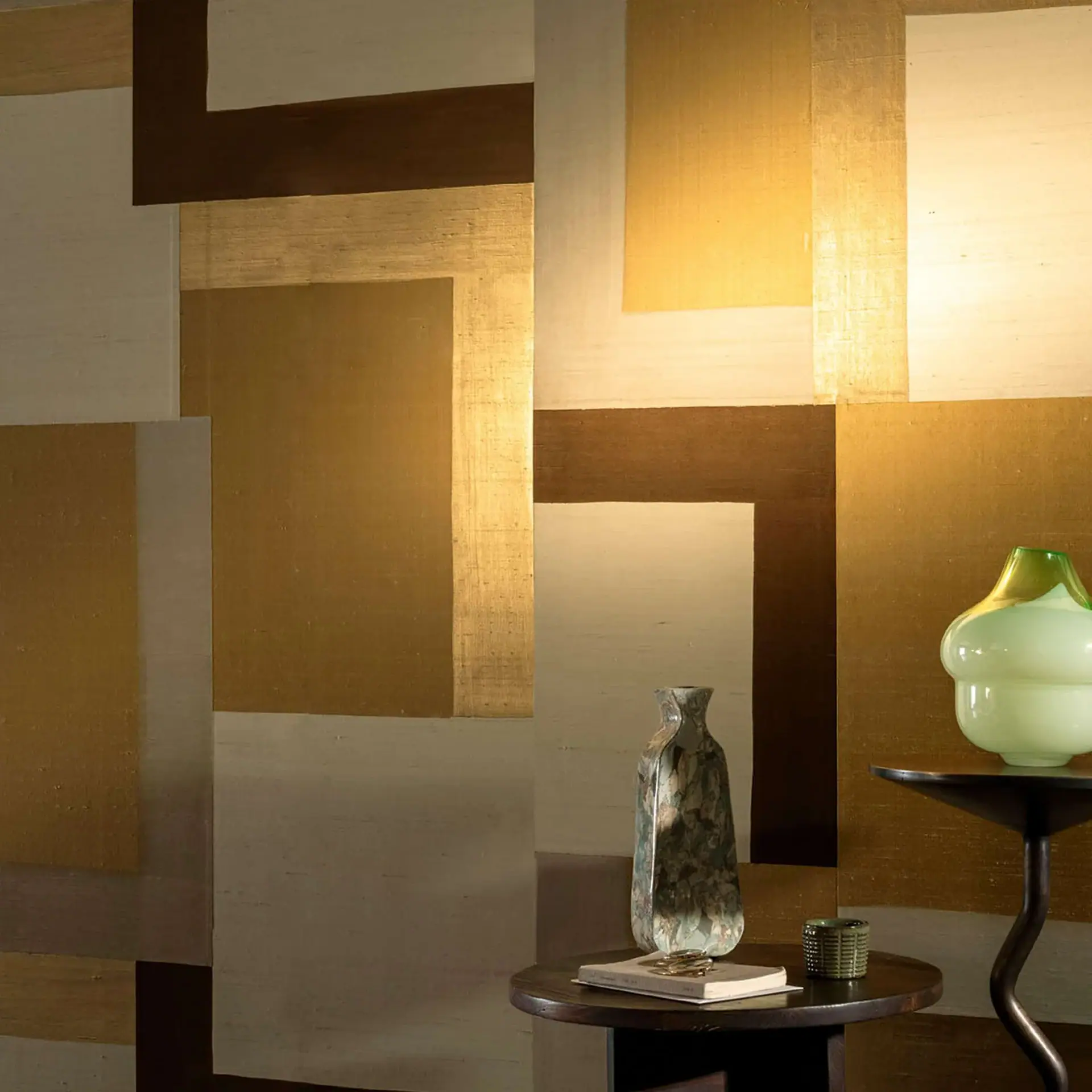 Geometric wall art panels with gold and brown tones in a stylish interior.