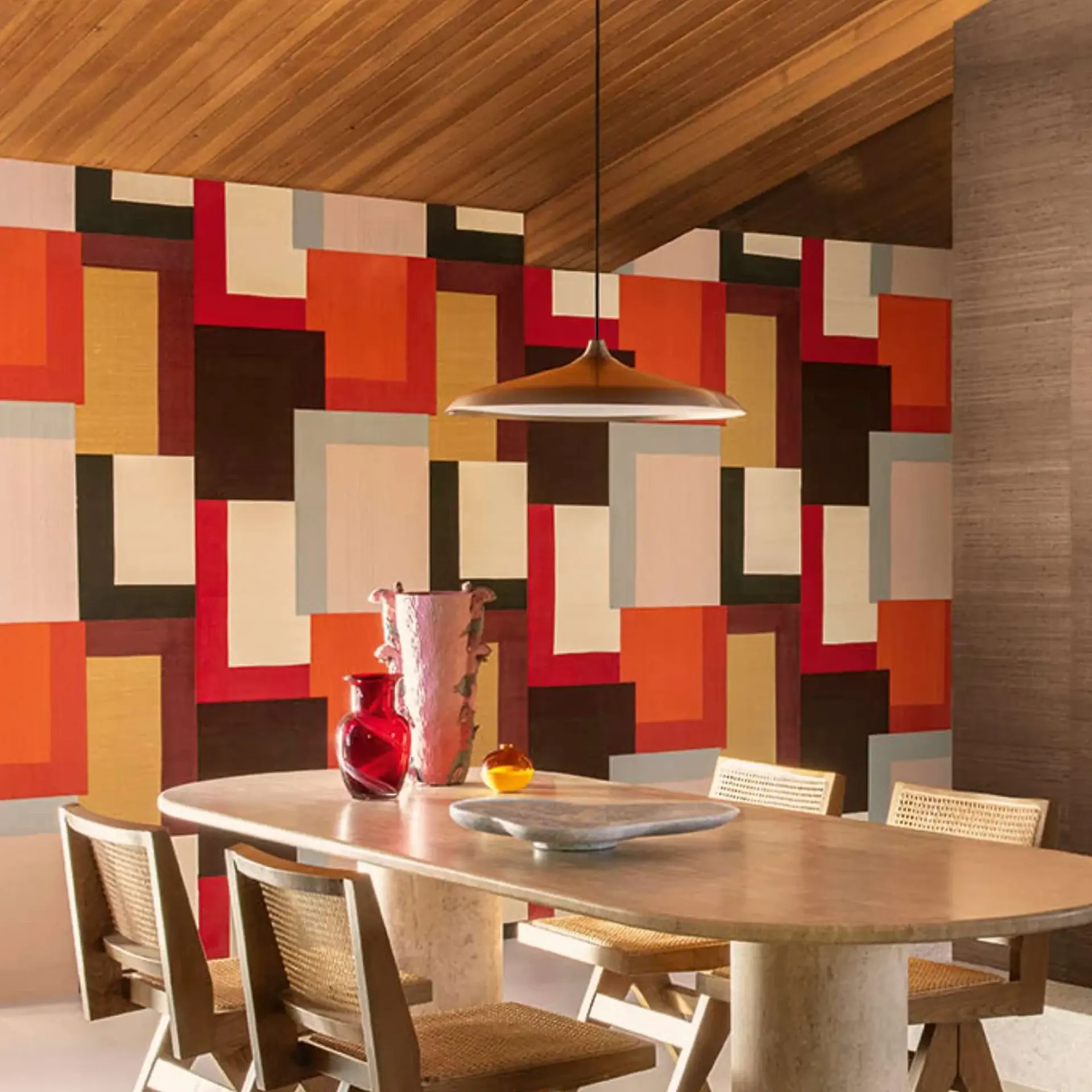 Geometric wall mural with multicolor blocks in dining room.