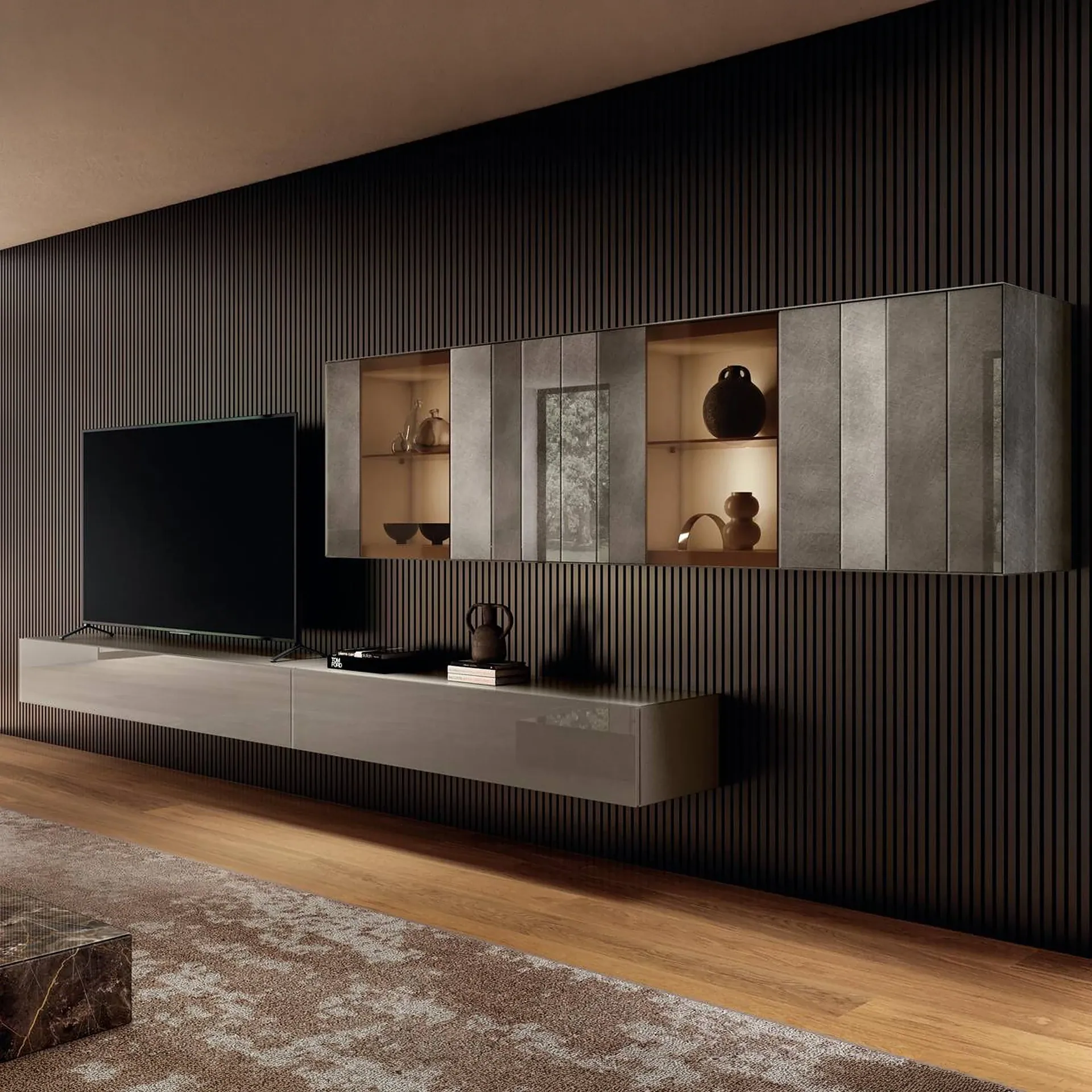 A modern living room with a large TV, floating media console, and illuminated wall cabinets against a dark, slatted accent wall. A patterned rug covers part of the wooden floor.