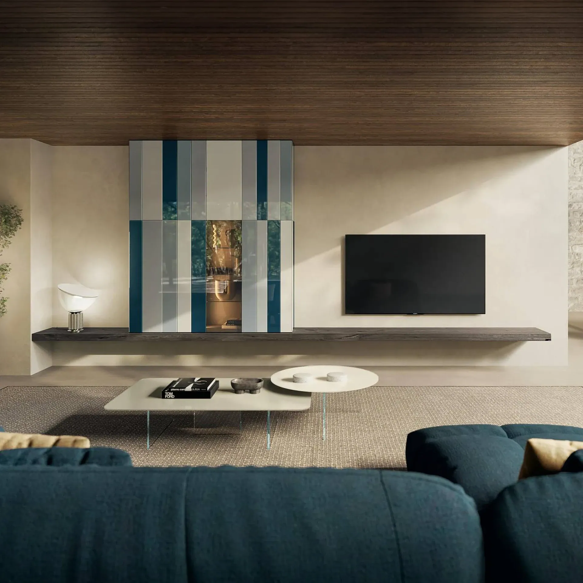 A modern living room with a striped cabinet, black TV, floating shelf, and teal sofa on a textured rug.