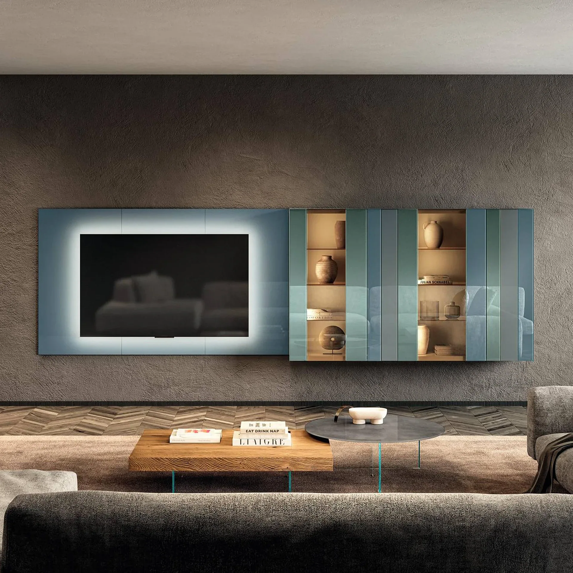 A modern living room with a wall-mounted TV and illuminated display cabinet, a dark gray sofa, and two coffee tables on a rug.