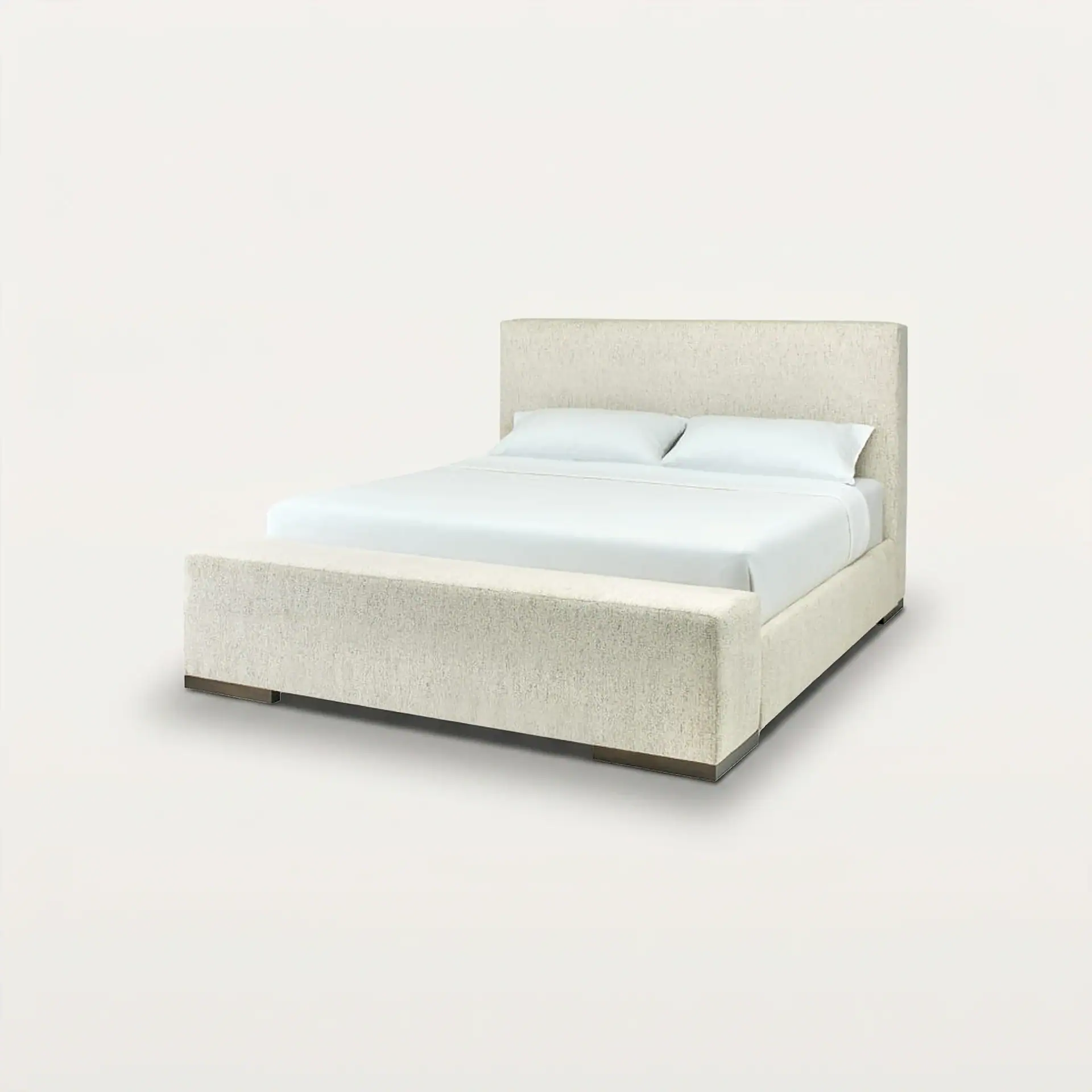 A light beige upholstered bed with a tall headboard, white bedding, and a matching footboard bench, set against a plain light background.